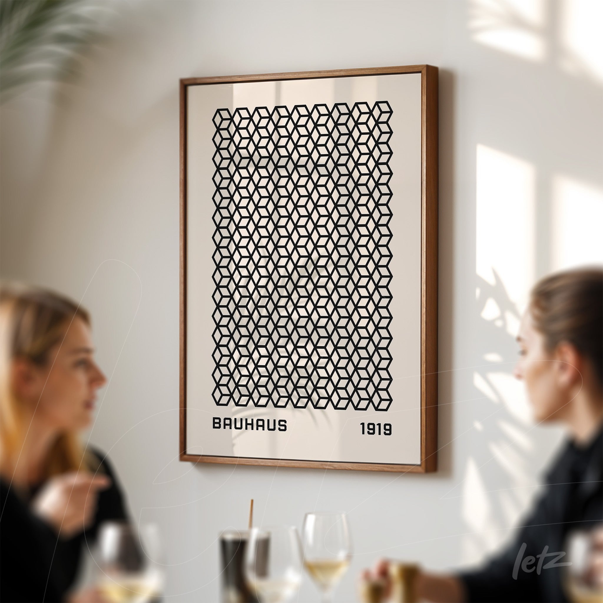 framed artwork with black geometric pattern on a white wall, surrounded by a wooden frame