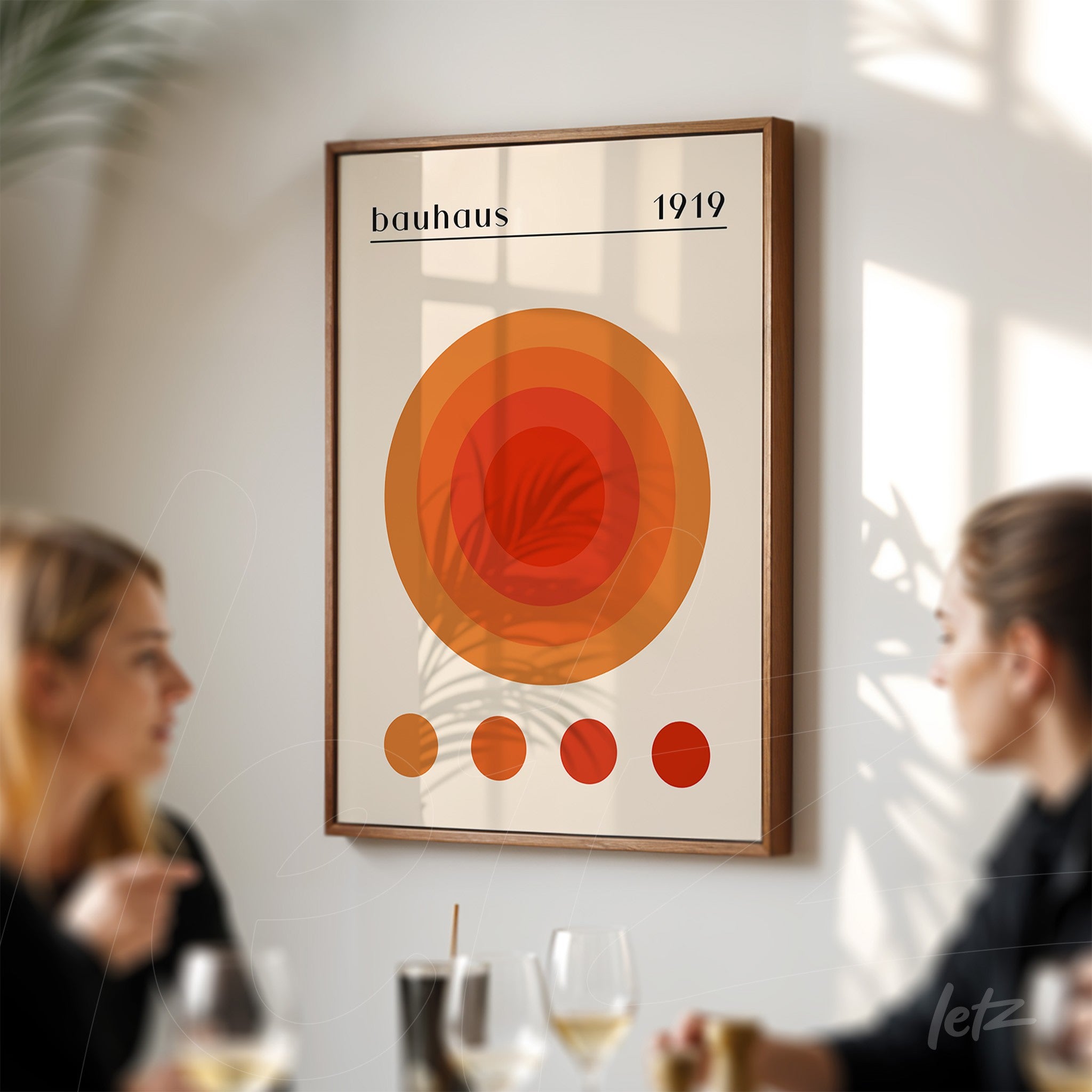 bauhaus style framed wall art with concentric orange circles and wooden frame