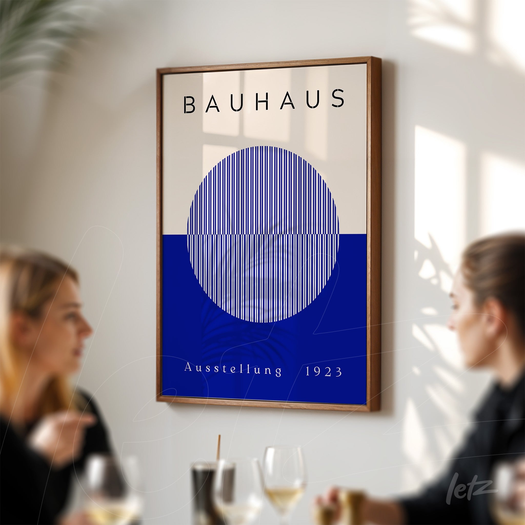 framed poster print of bauhaus geometric design on sunlit wall with a wooden frame