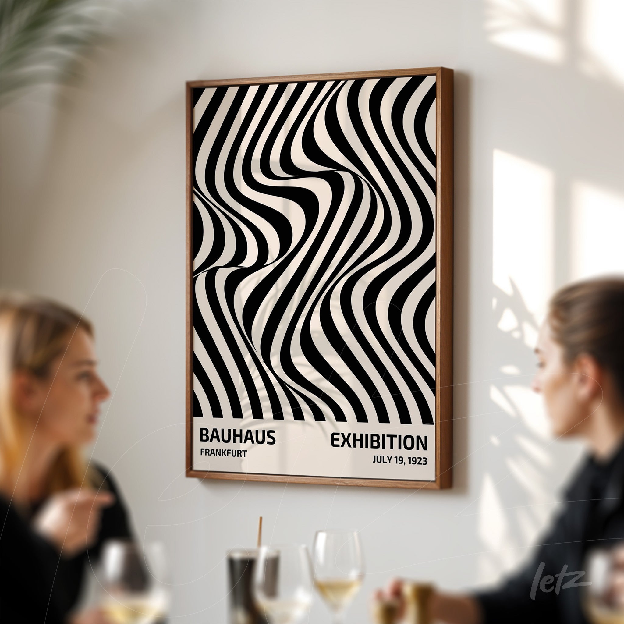 framed poster with black and white abstract geometric pattern displayed on a white wall