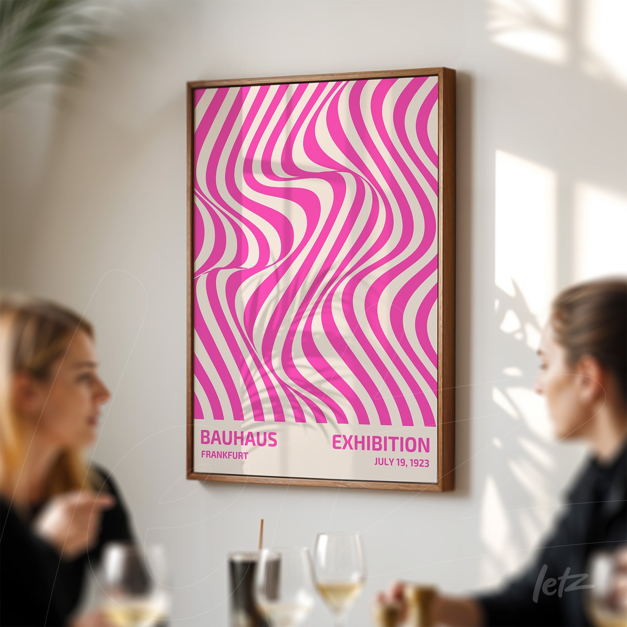 framed abstract art with wavy pink and white geometric patterns in wooden frame displayed on a white wall