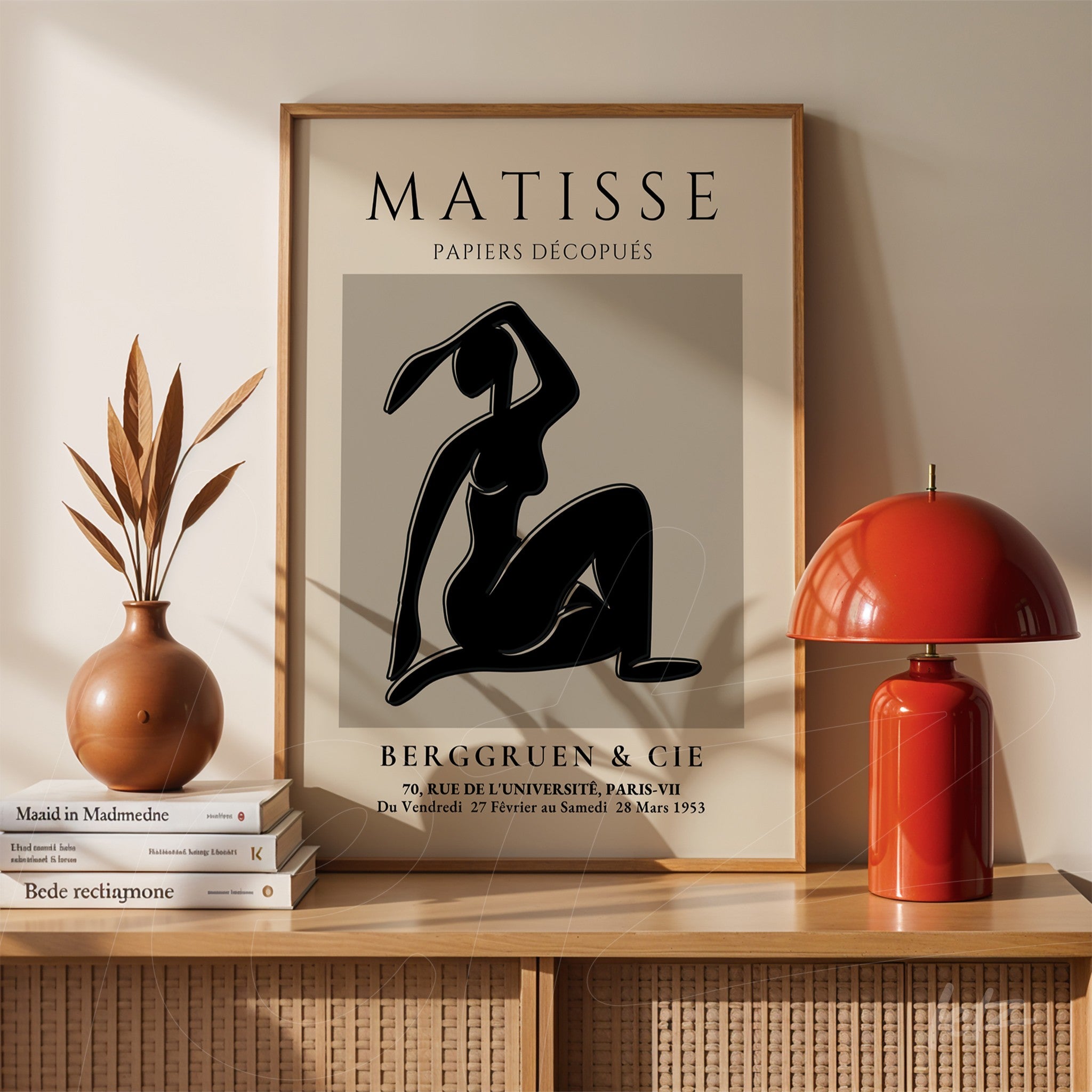 framed wall art of stylized human figure on gray background with light frame and displayed on wooden table
