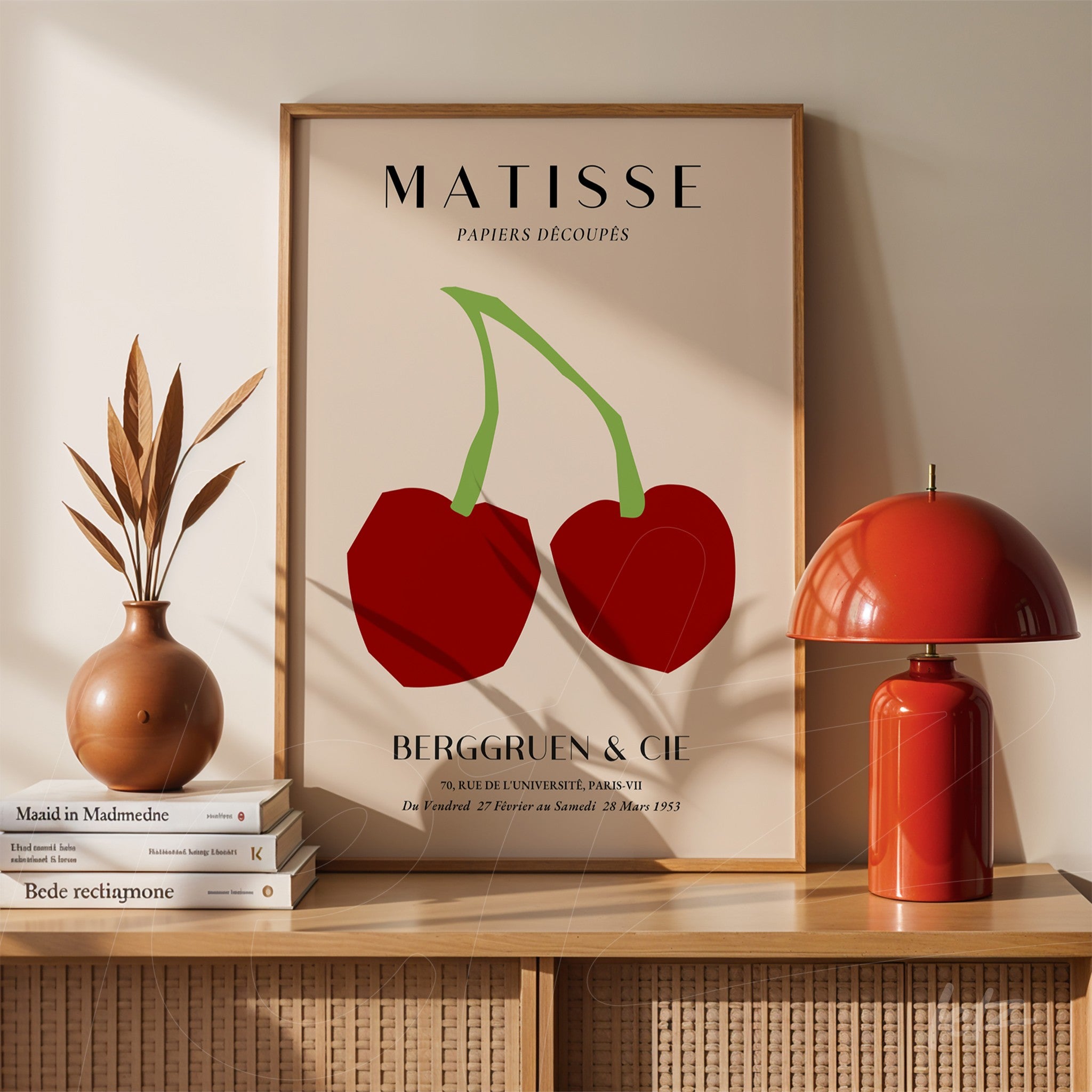 framed modern art print of two red cherries on light background with classic frame displayed on minimalistic table decor