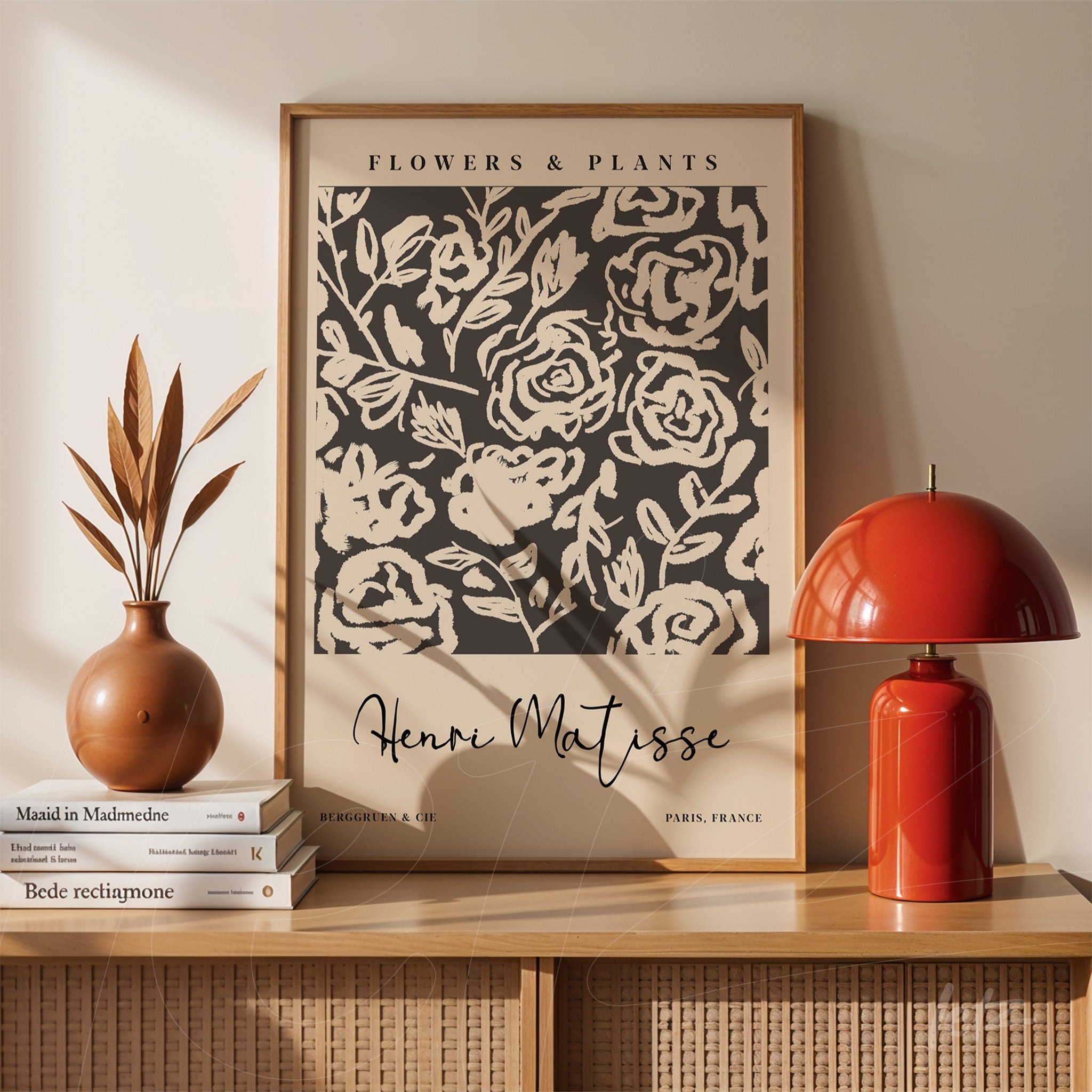 framed wall art featuring floral patterns on a dark background, displayed on a table with a vase and a lamp