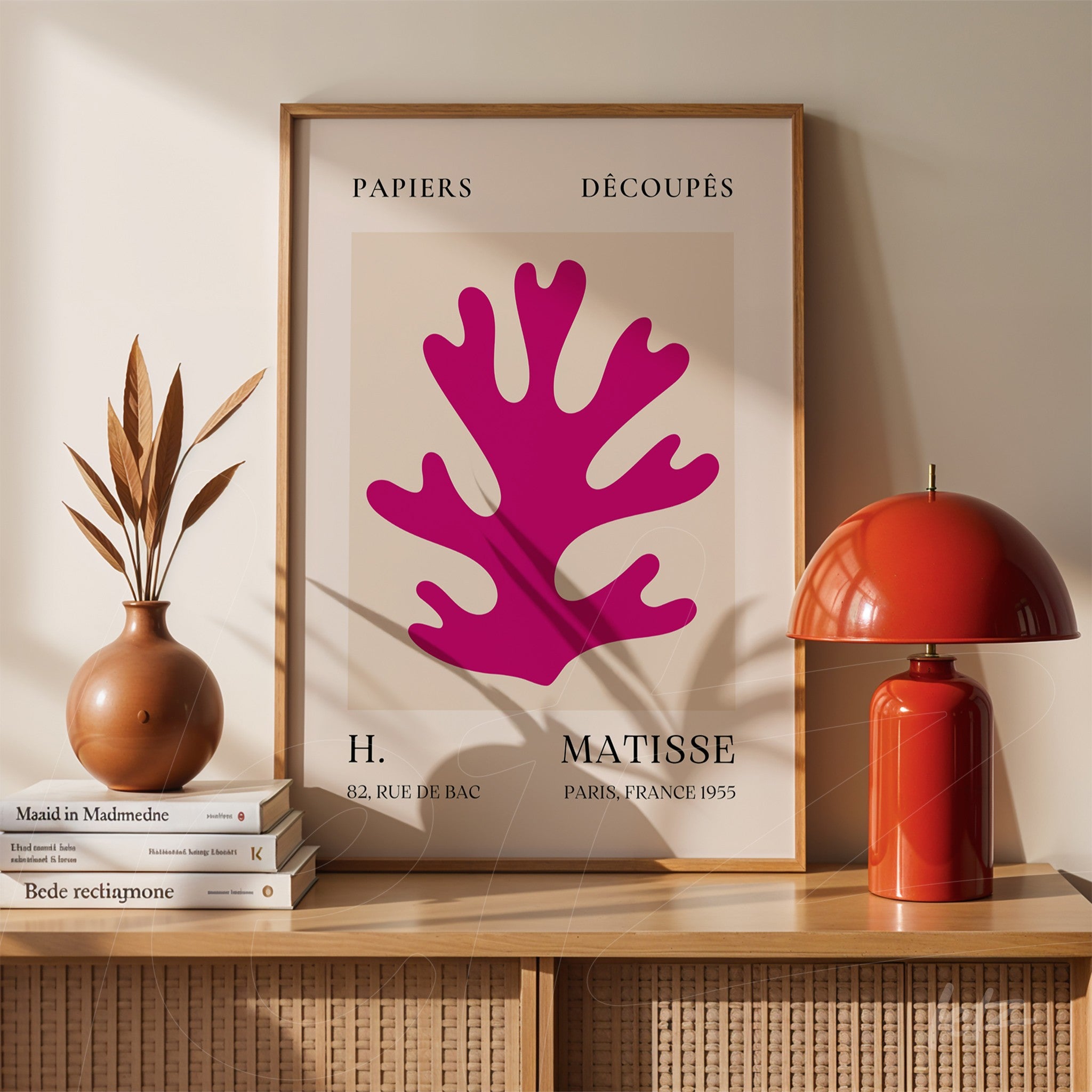 framed modern art of vibrant pink coral displayed on wooden table with decorative vases