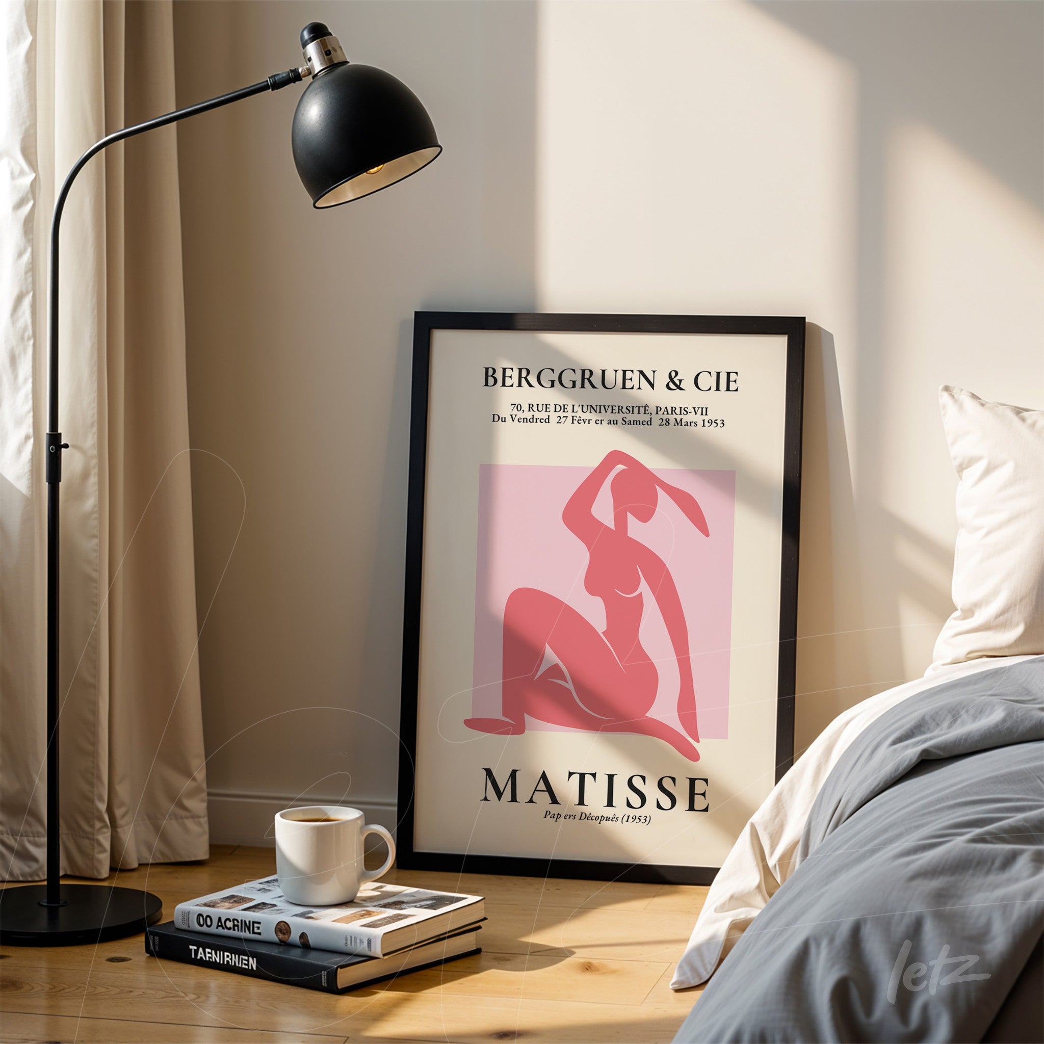 modern art print featuring a feminine figure in pink and red tones, framed in black, leaning beside a floor lamp in a light room
