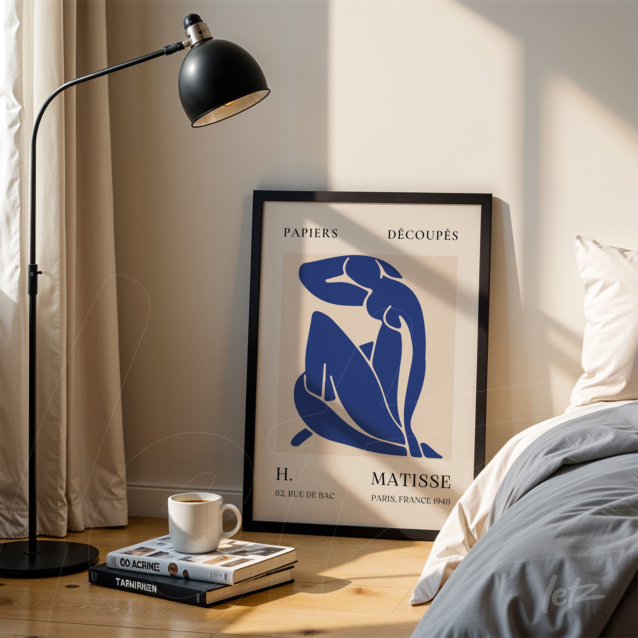 framed modern art print in blue and cream depicting a female figure, placed next to a lamp in a serene setting