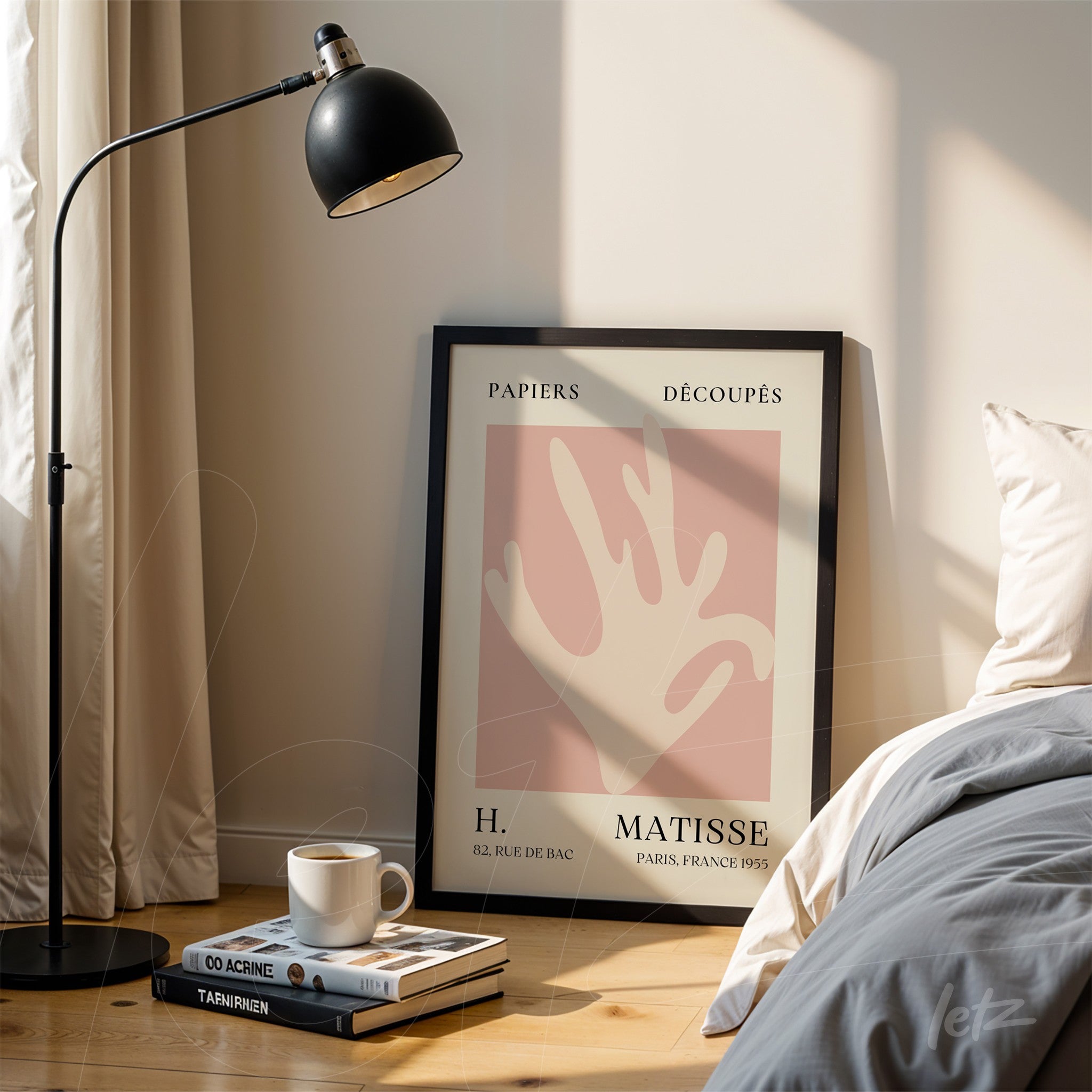 framed wall art featuring Matisse design on wooden floor illuminated by a lamp beside a bed with light bedding