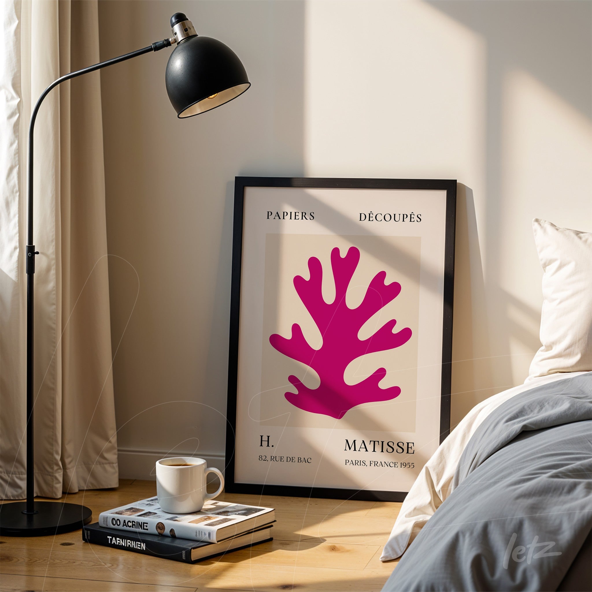 framed wall art featuring abstract coral shape in pink hues, set beside floor lamp in a softly lit room