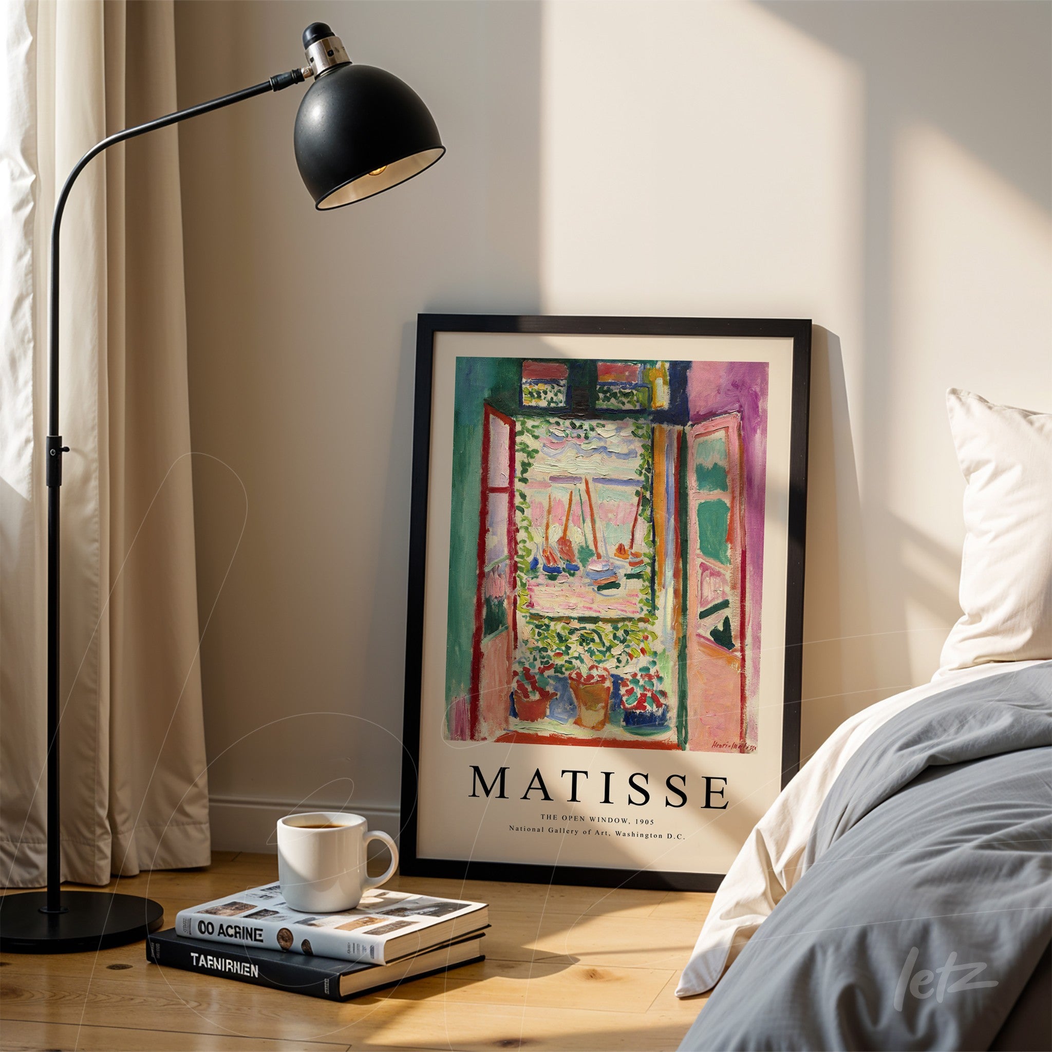 framed wall art of a seaside landscape by Matisse, leaning next to a lamp and bed with light bedding