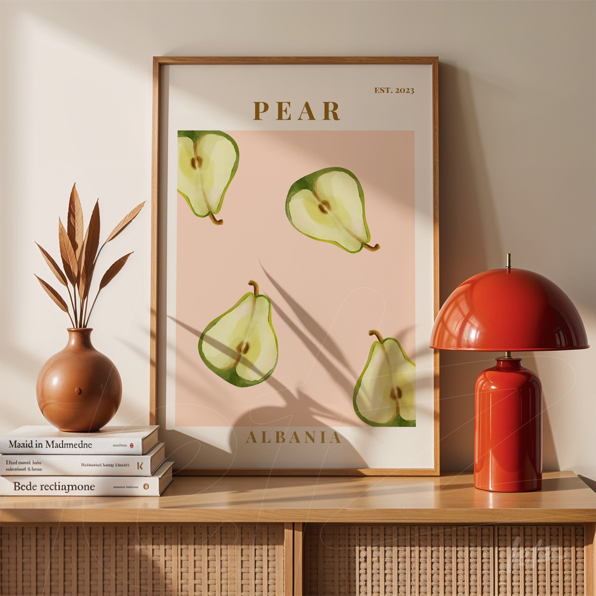 framed wall art featuring minimalist illustration of pears on pink background with gold text