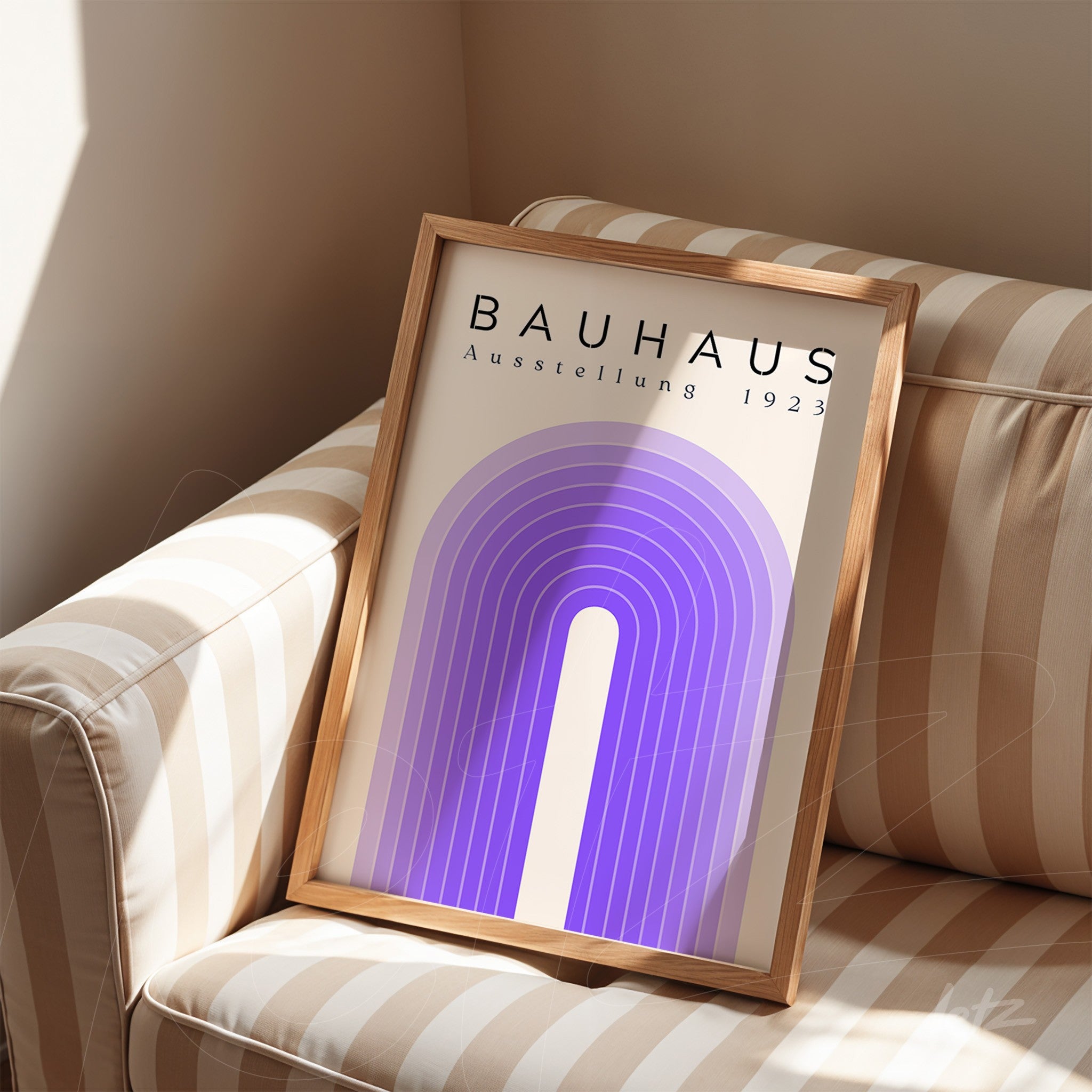 modern geometric art with purple arches and bauhaus title in light wooden frame resting on striped sofa