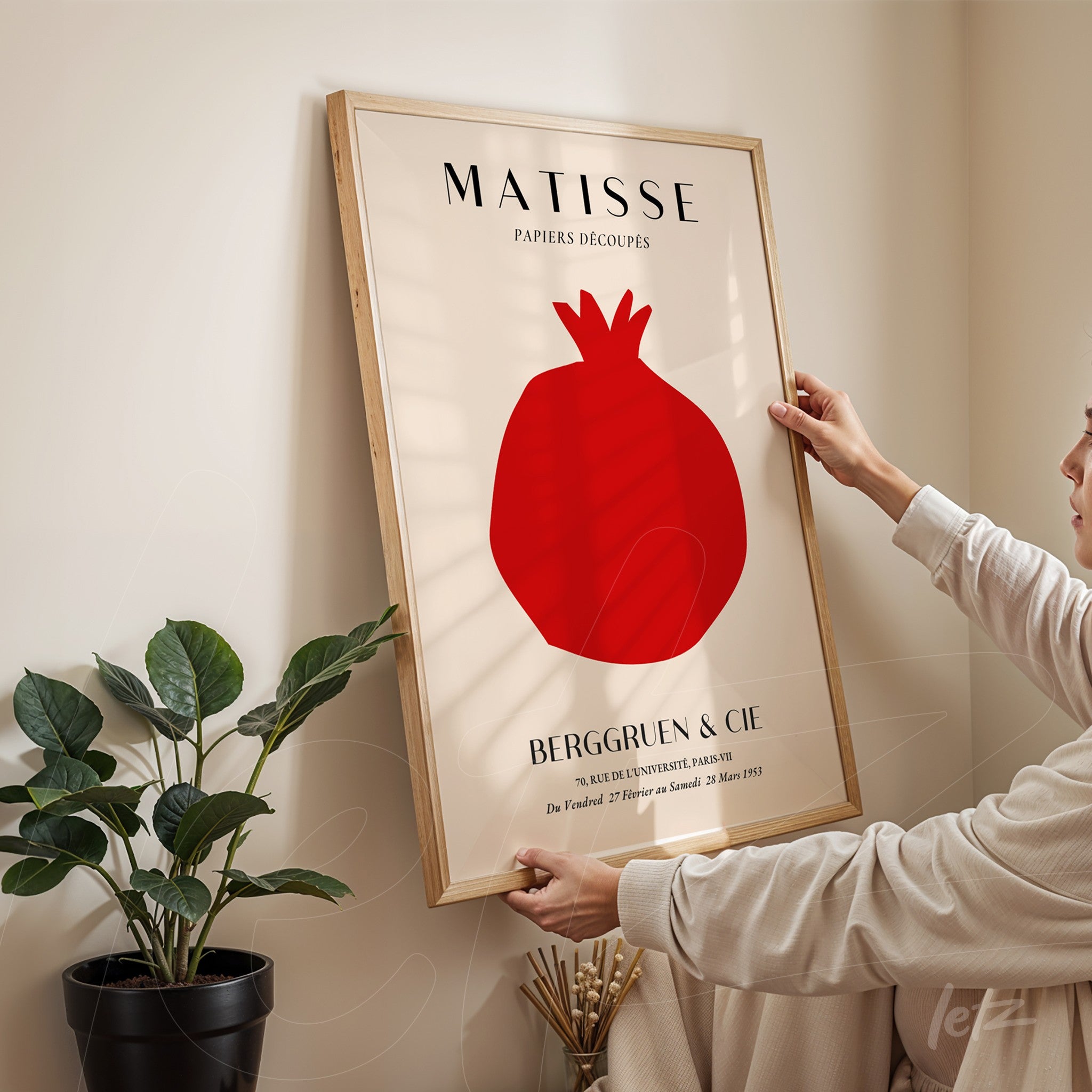 framed artwork inspired by Matisse featuring a red pomegranate with a light wood frame