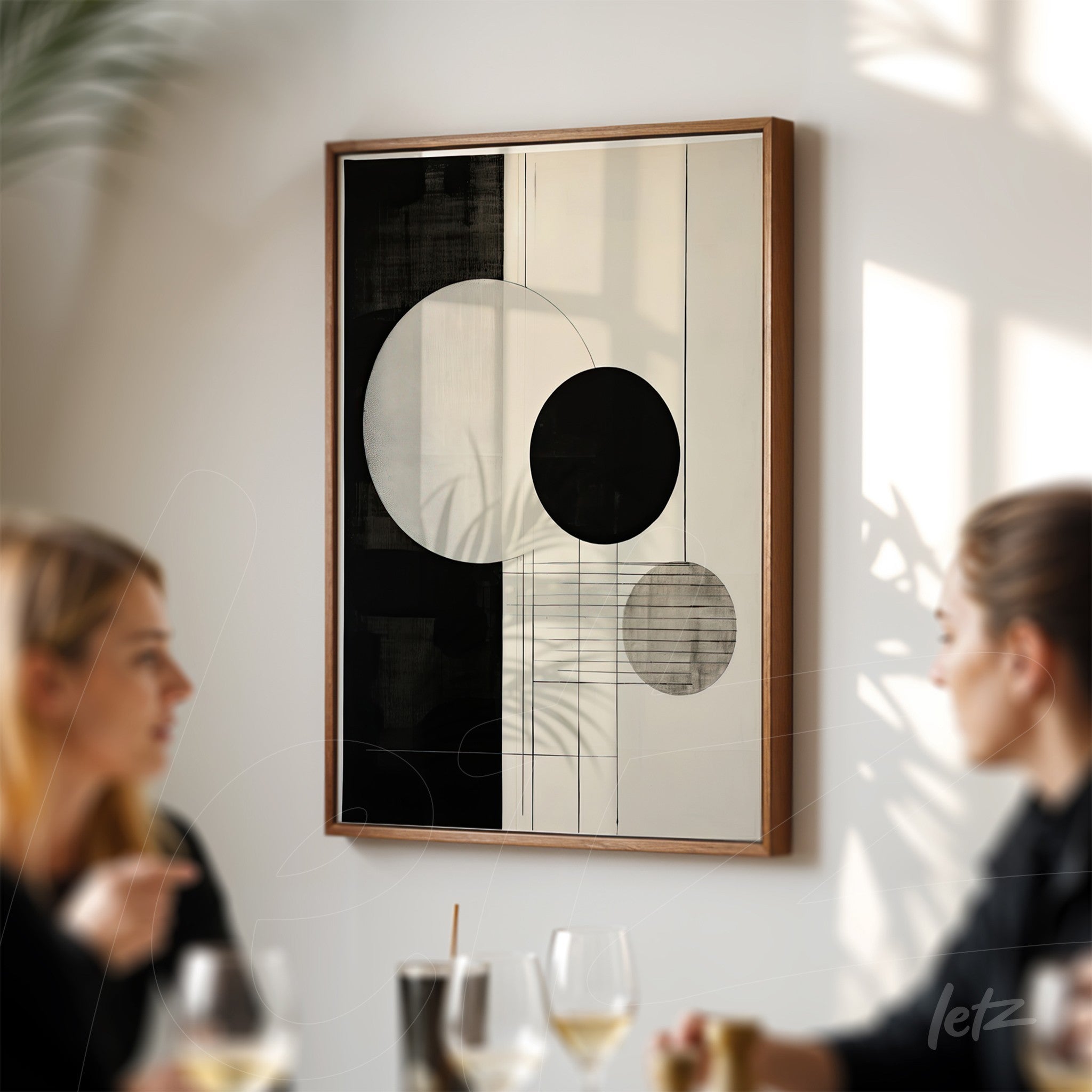 modern wall art featuring geometric shapes in black and white with light wood frame