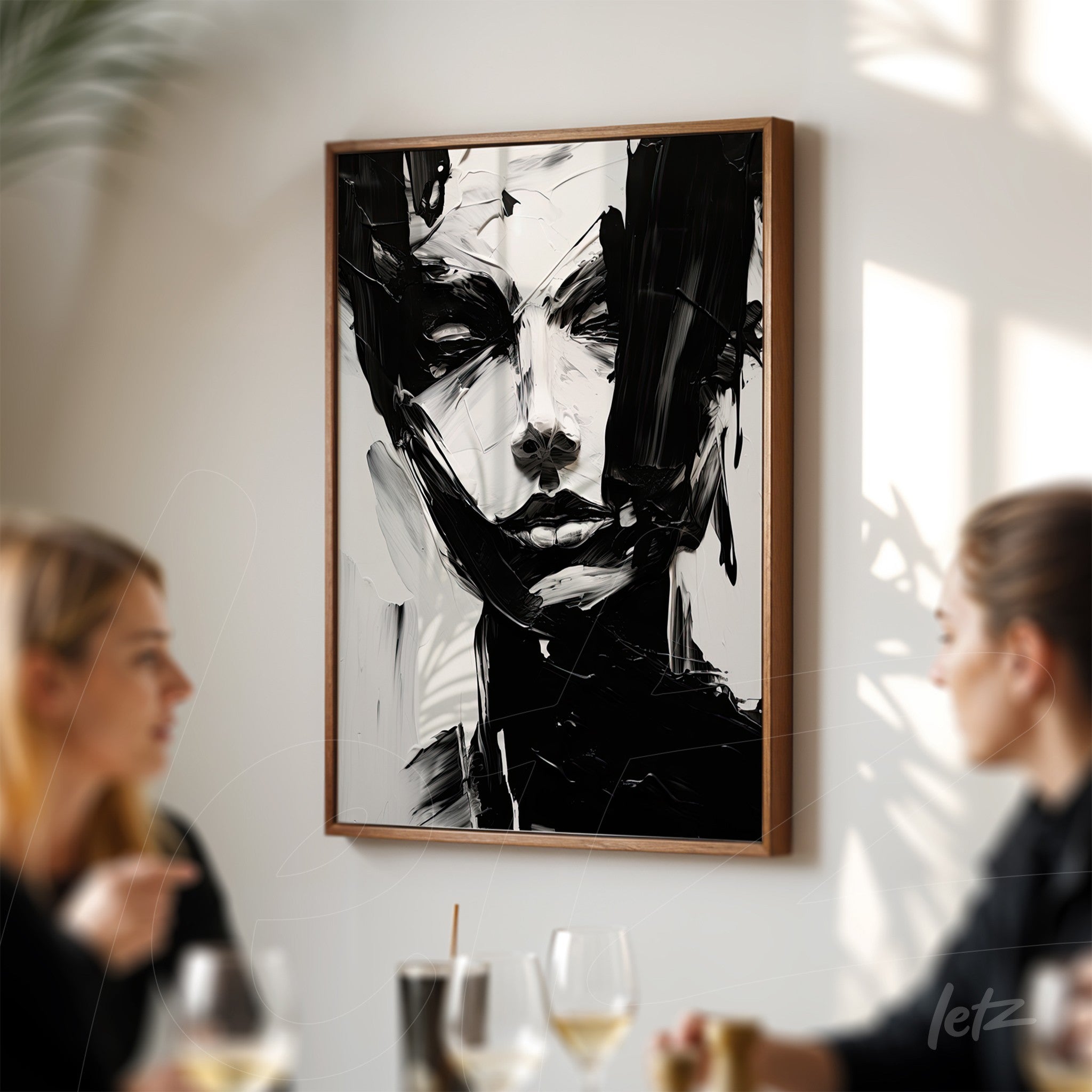abstract art piece featuring a black and white portrait in a light wood frame