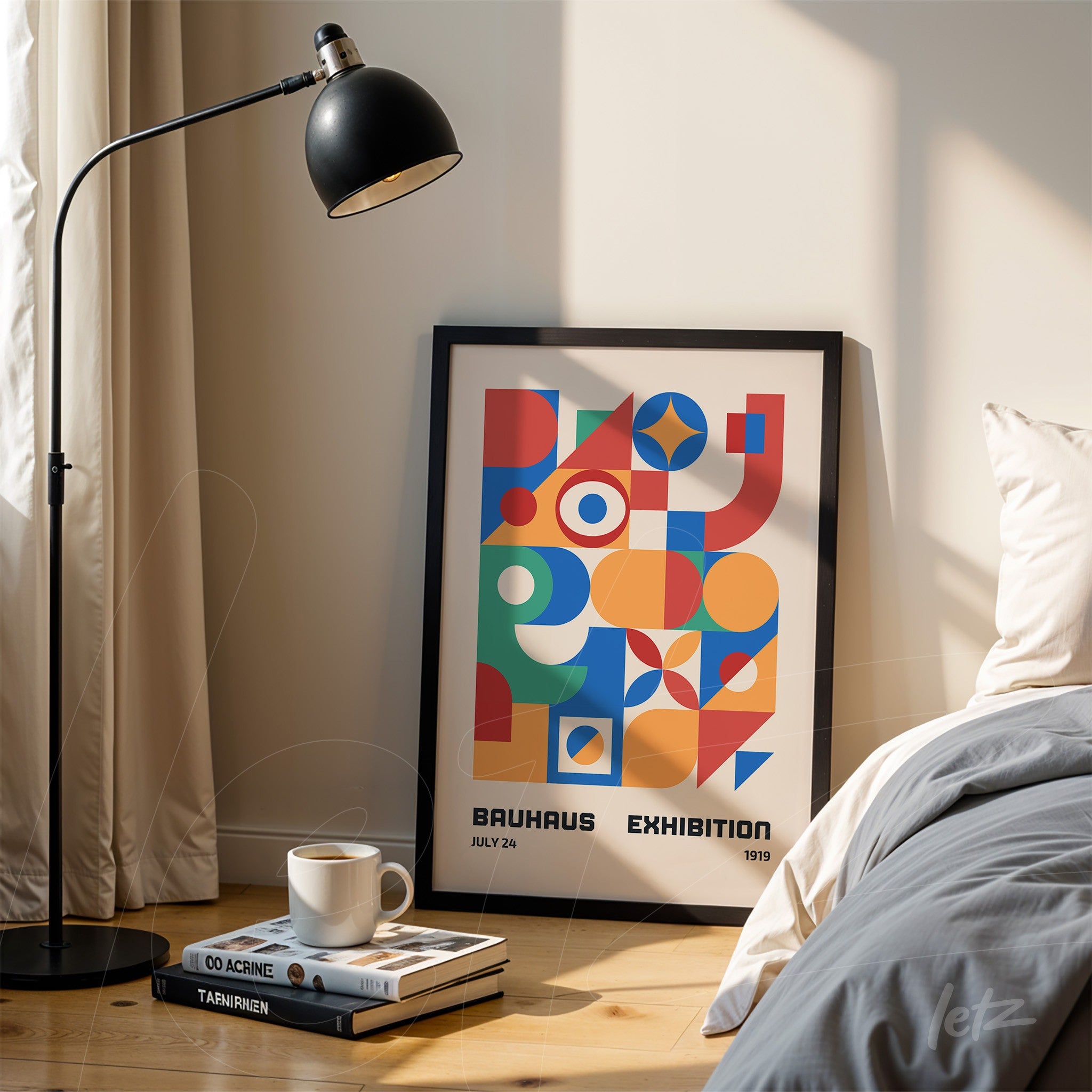 poster with colorful geometric illustration and bauhaus exhibition text framed in black, leaning on the floor next to a bed