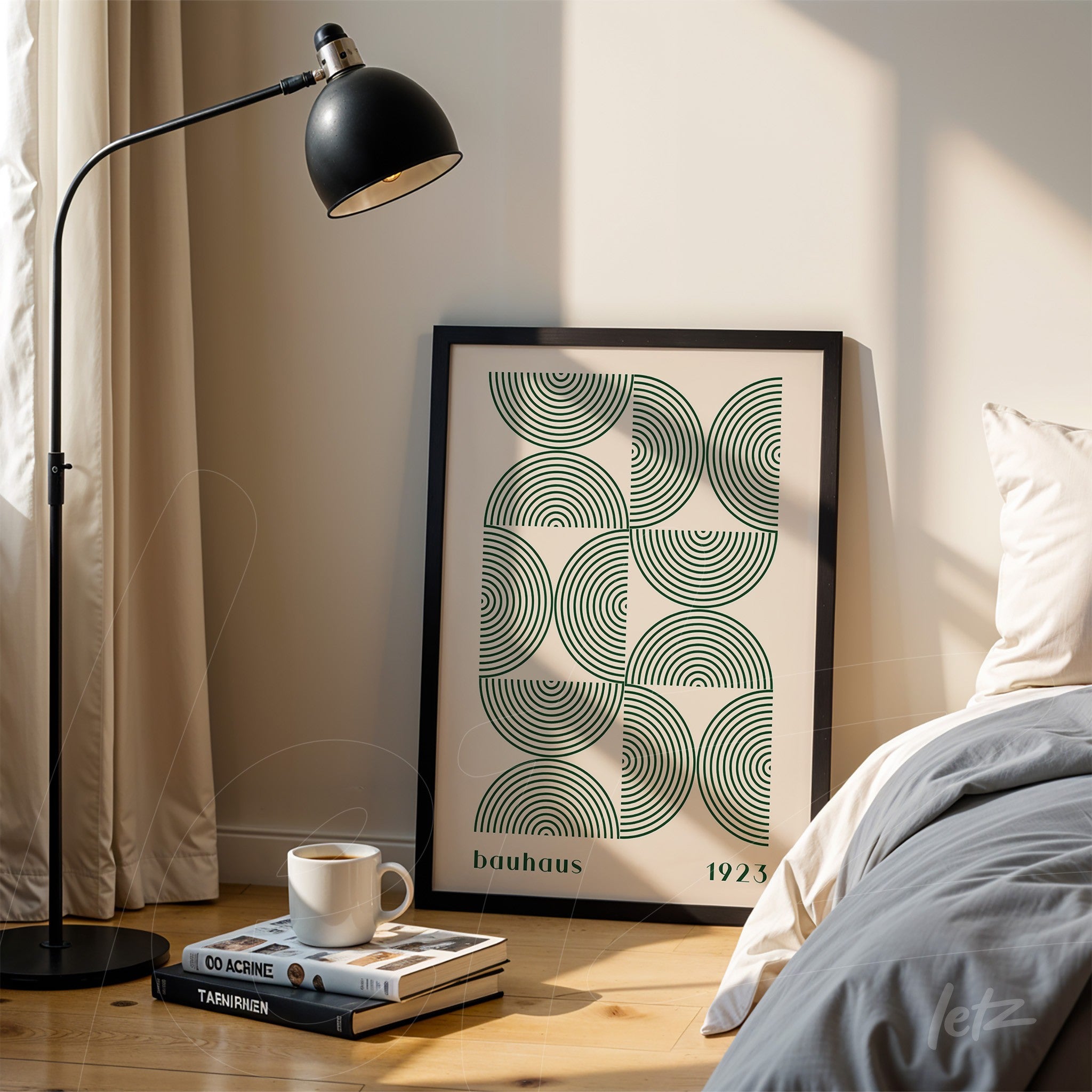 bauhaus style geometric art poster in black frame resting on wooden floor beside modern lamp