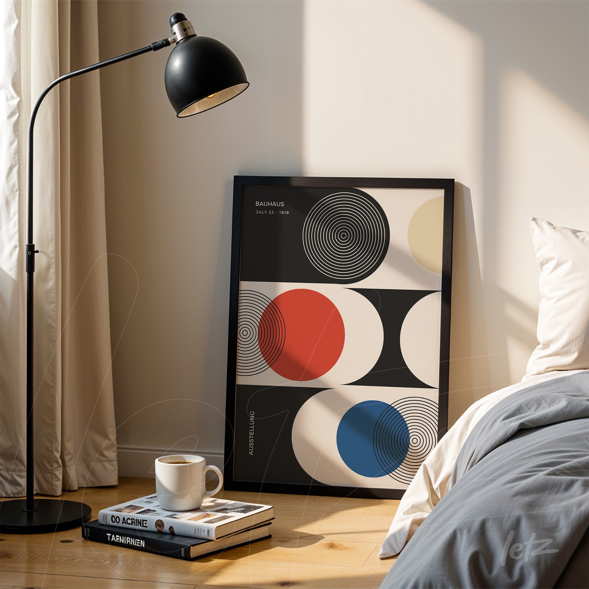 inspiring graphic art with geometric shapes in black, red, blue, and cream, housed in a black frame, set against books and a lamp in a cozy setting