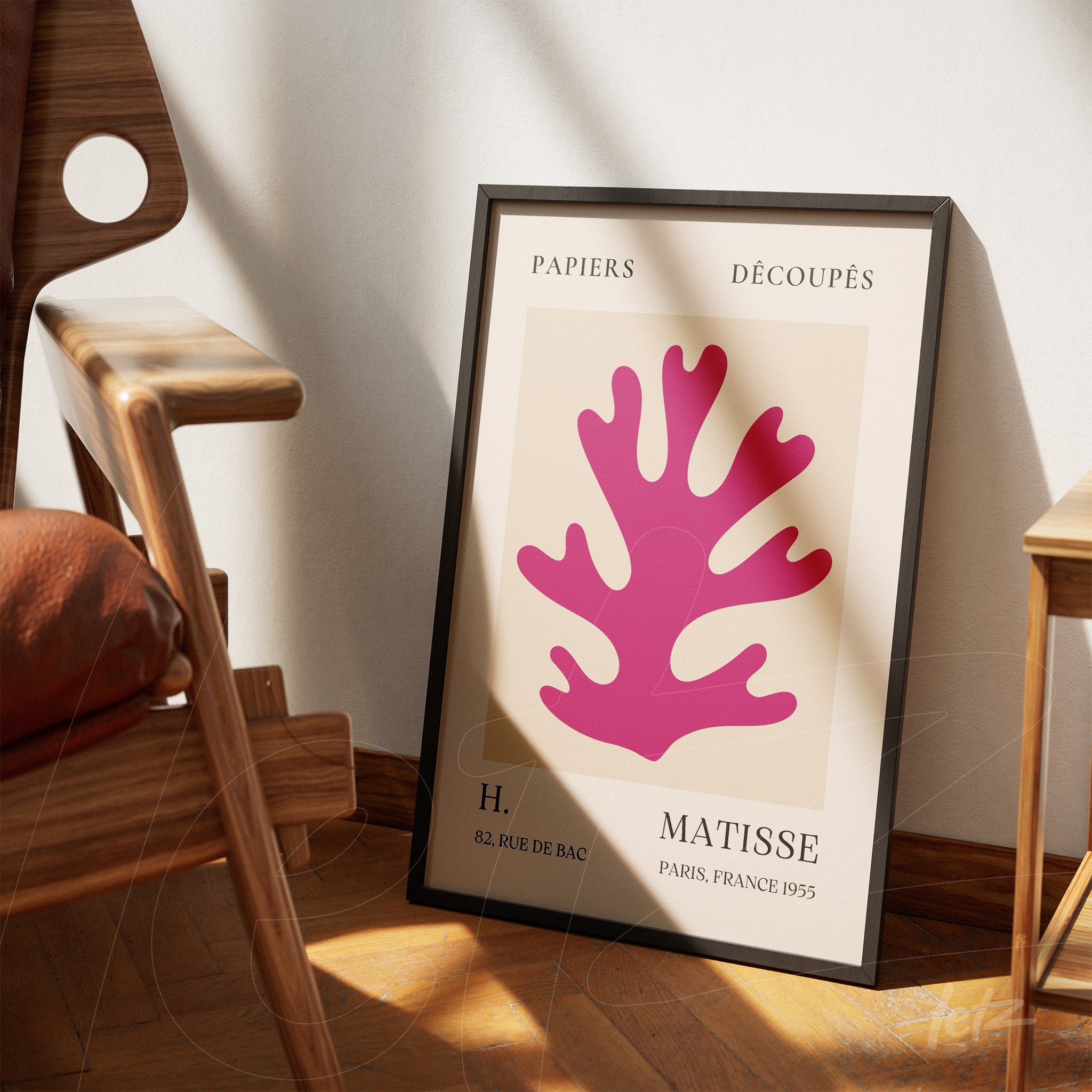 modern art framed print featuring pink coral cutouts displayed against wooden floor