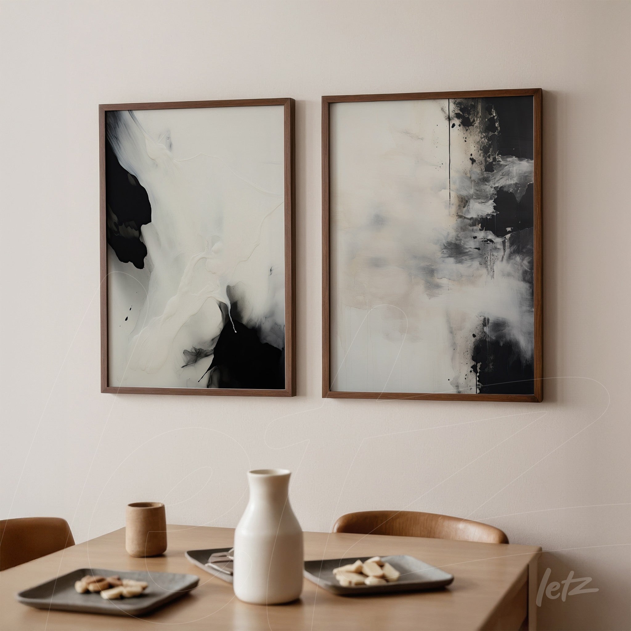 pair of abstract framed artworks in dark wood frames on a light wall