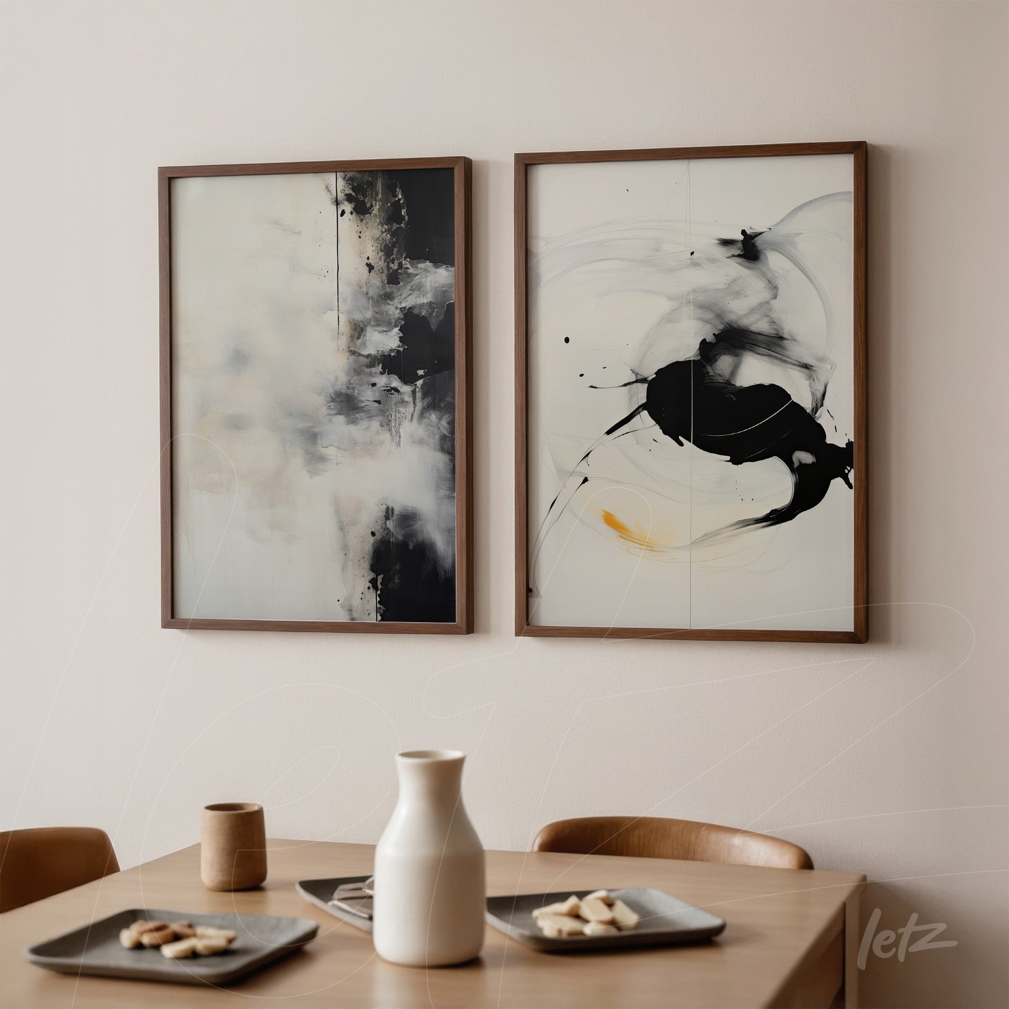 composition of abstract wall art in wooden frames, one featuring a light background with dark splashes and the other with a dark hue and fluid shapes in white and black