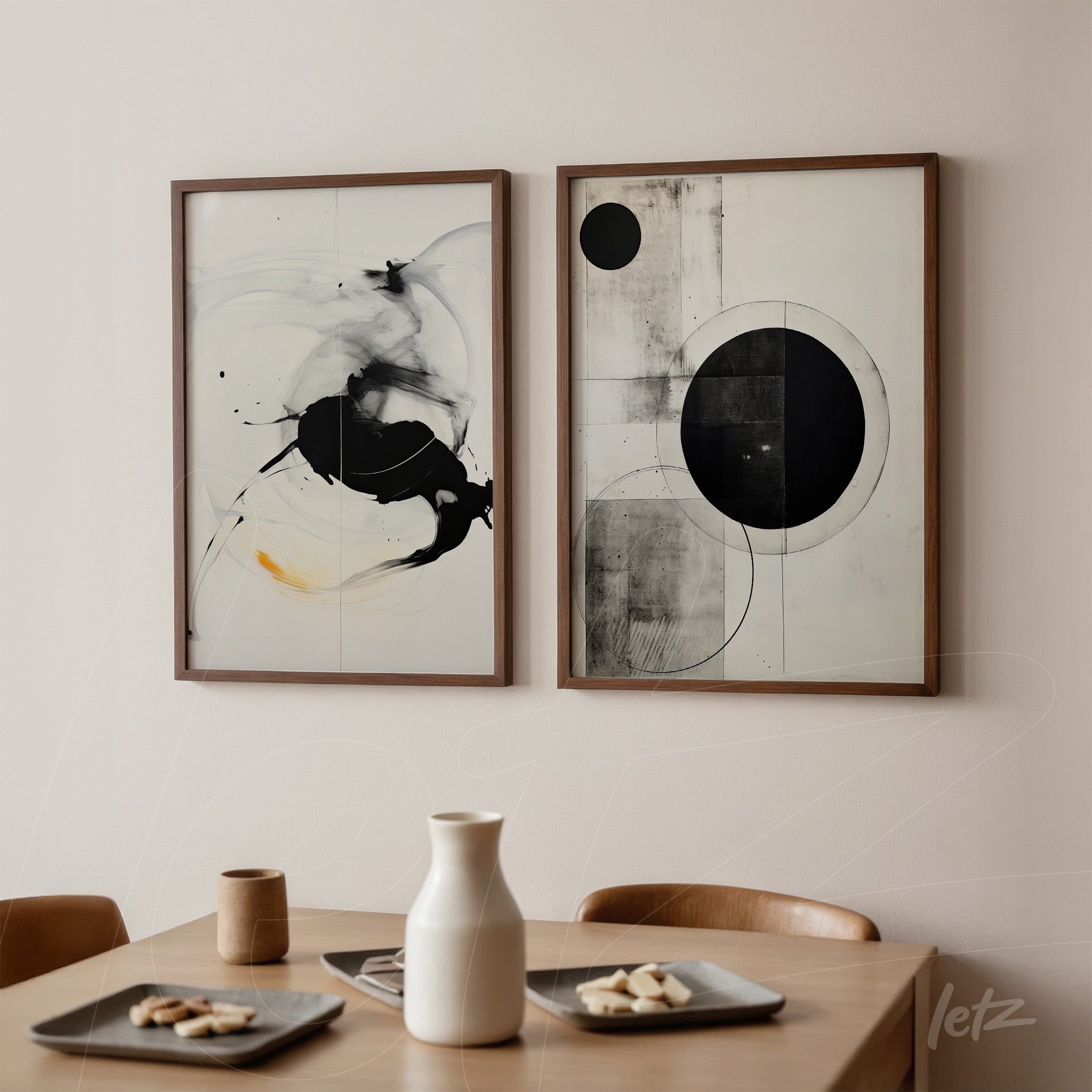 series of abstract black and white wall art in wooden frames displayed on a light wall next to a wooden table with kitchenware