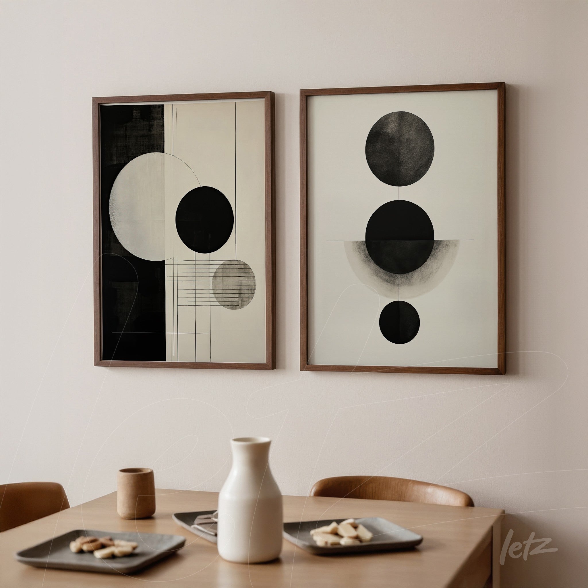 set of framed abstract black and white wall art, light wood frame, displayed on a neutral wall above a wooden table