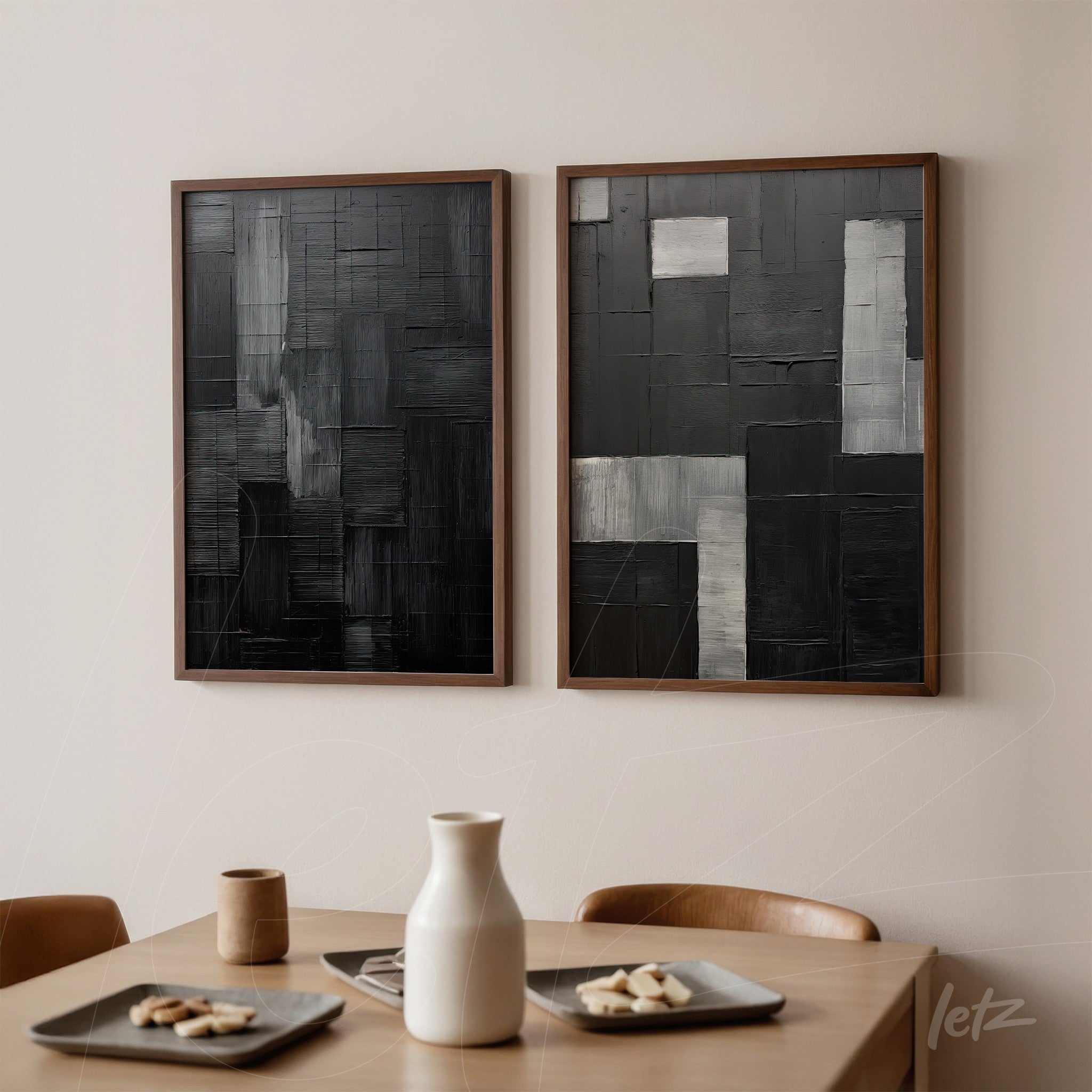 composition of abstract wall art in black and gray with wooden frame displayed on light wall