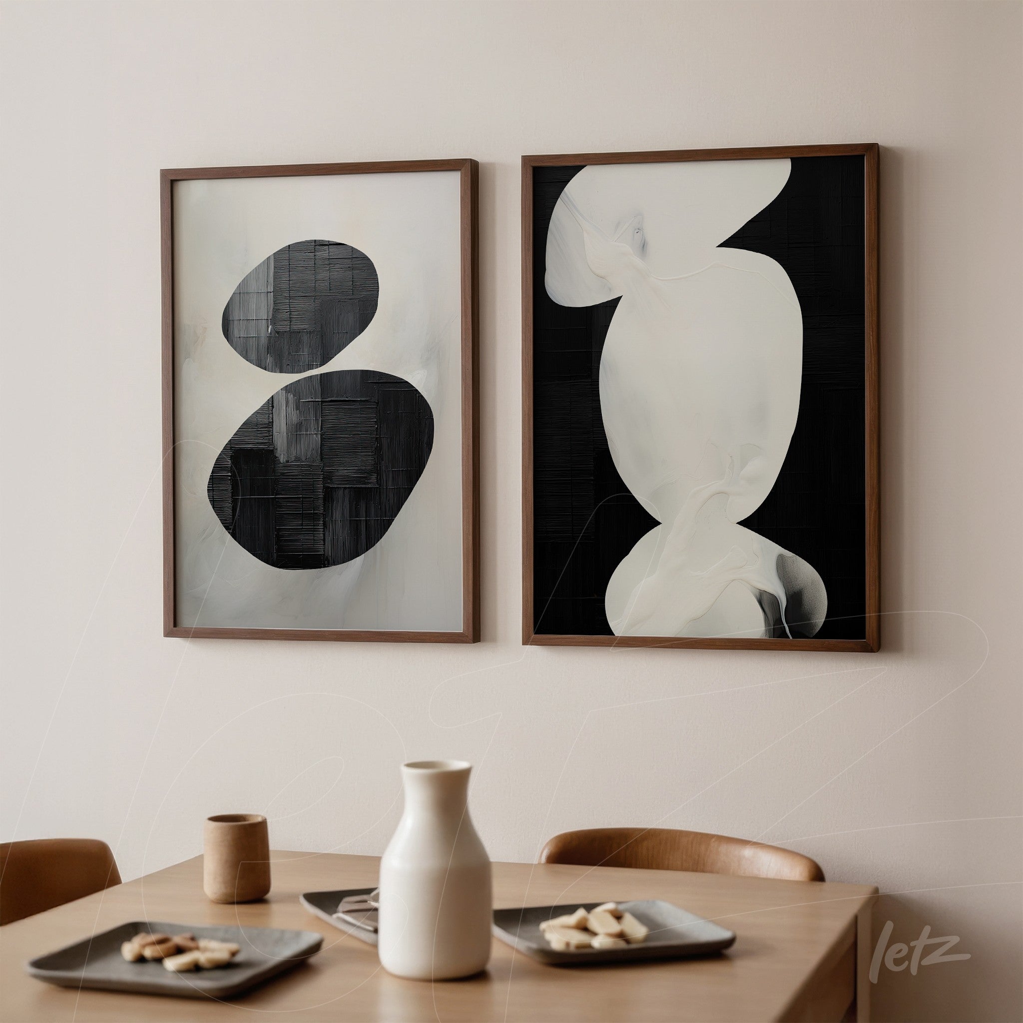 composition of abstract wall art in black and white with wooden frames displayed on a light wall