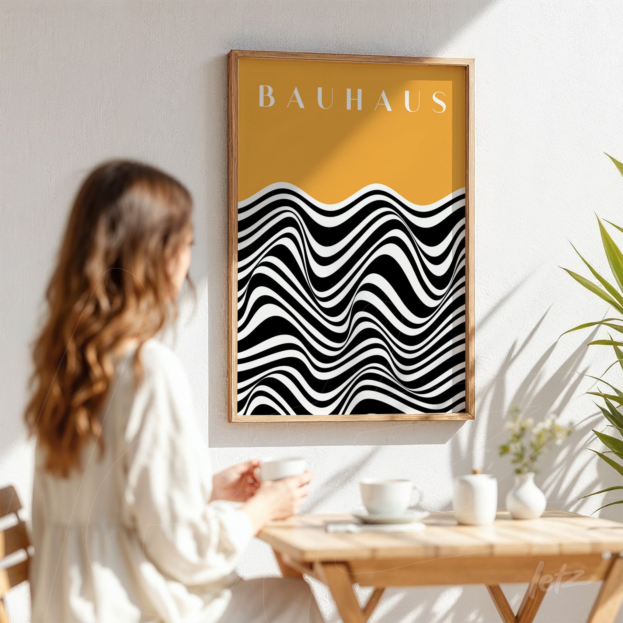geometric black and white wave art on yellow background in a wooden frame displayed on white wall