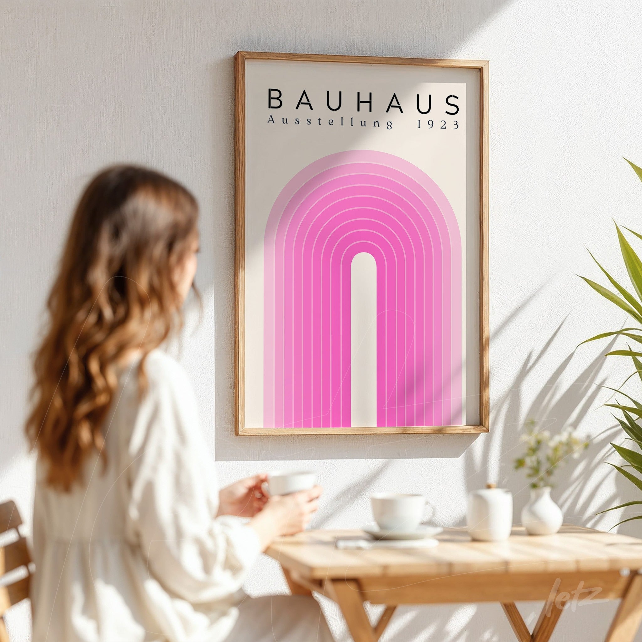 poster featuring geometric bauhaus style art in wooden frame hanging on a light wall