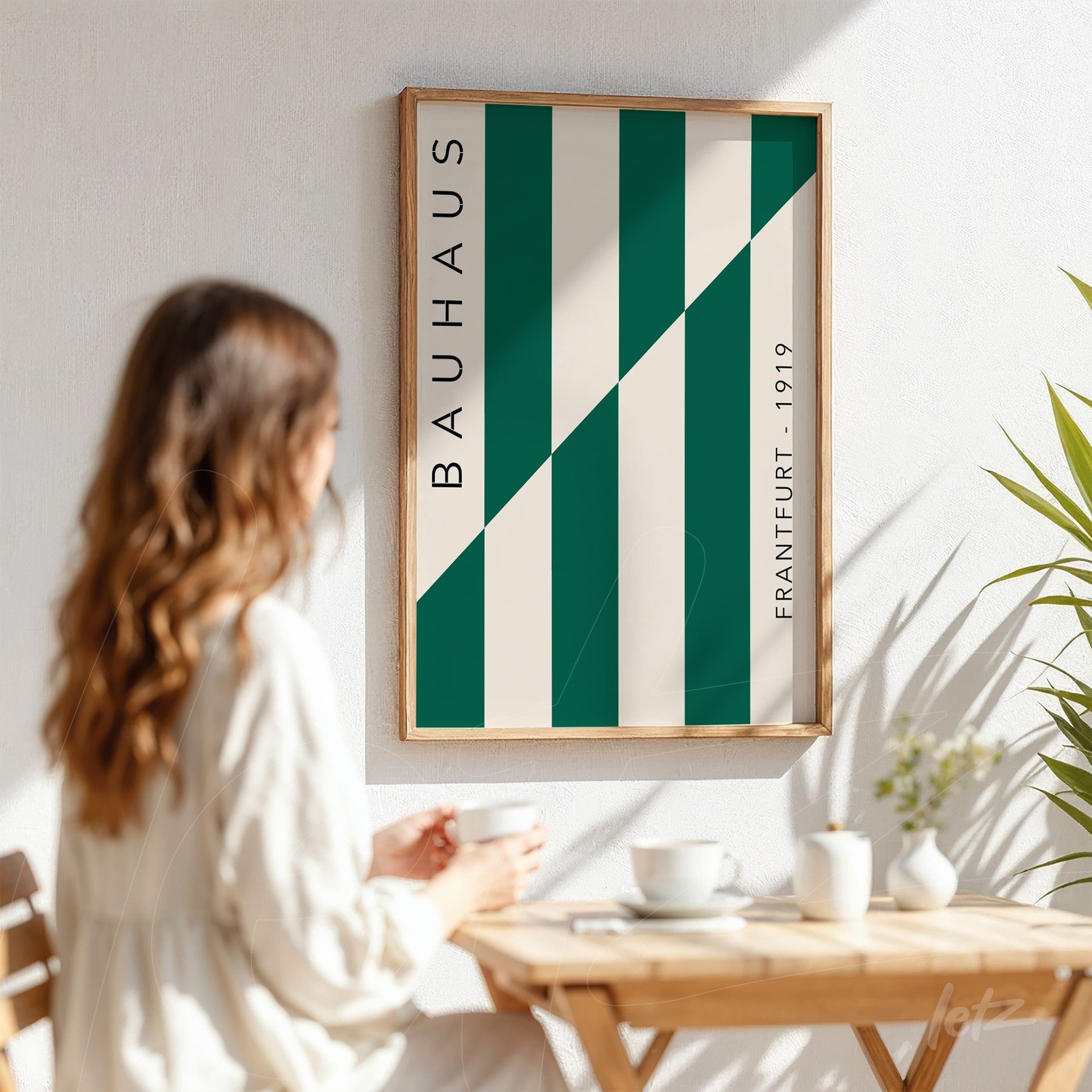 poster with vertical green and white stripes in bauhaus style framed in light wood