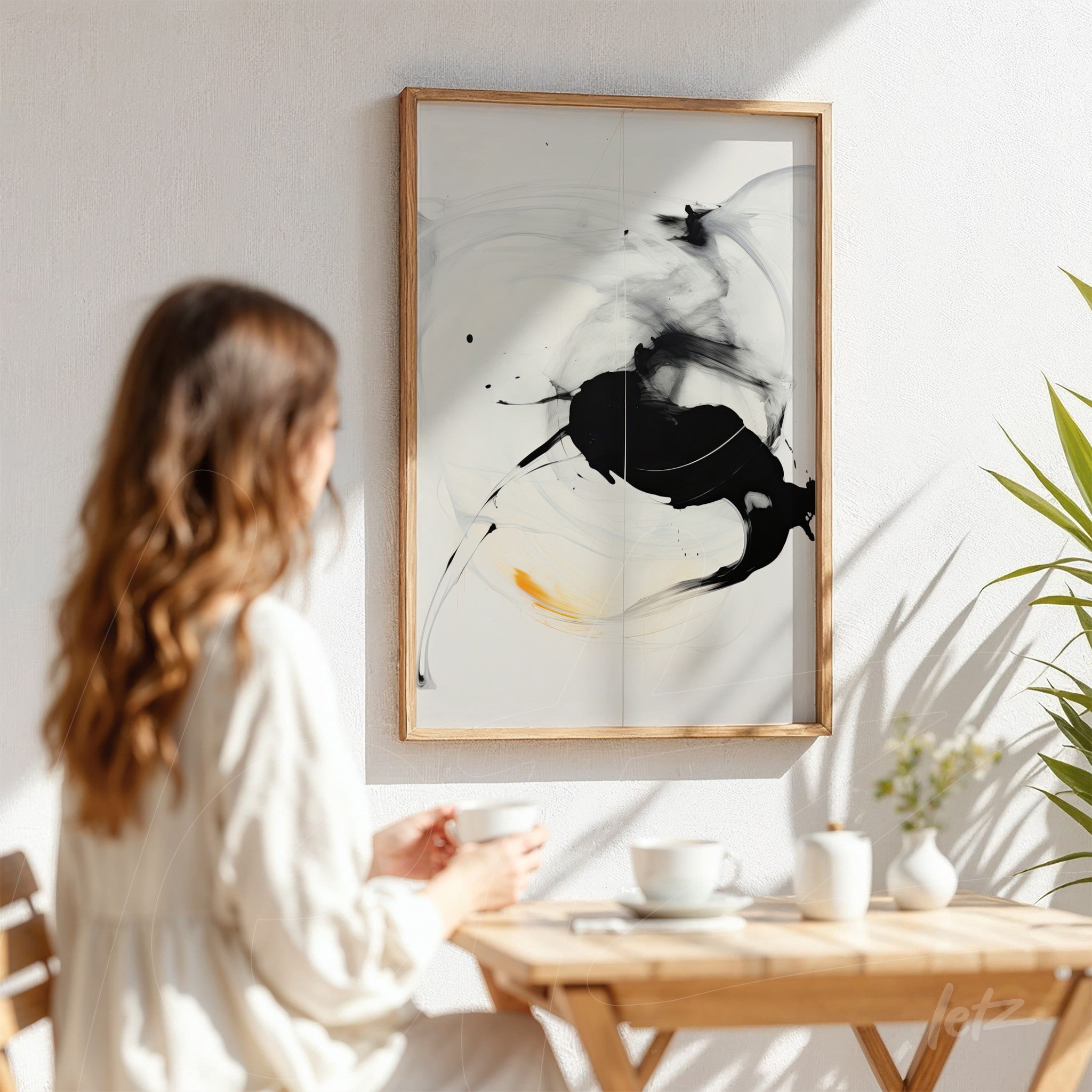 modern abstract artwork in black and white, framed with a light wood frame, displayed against a white wall