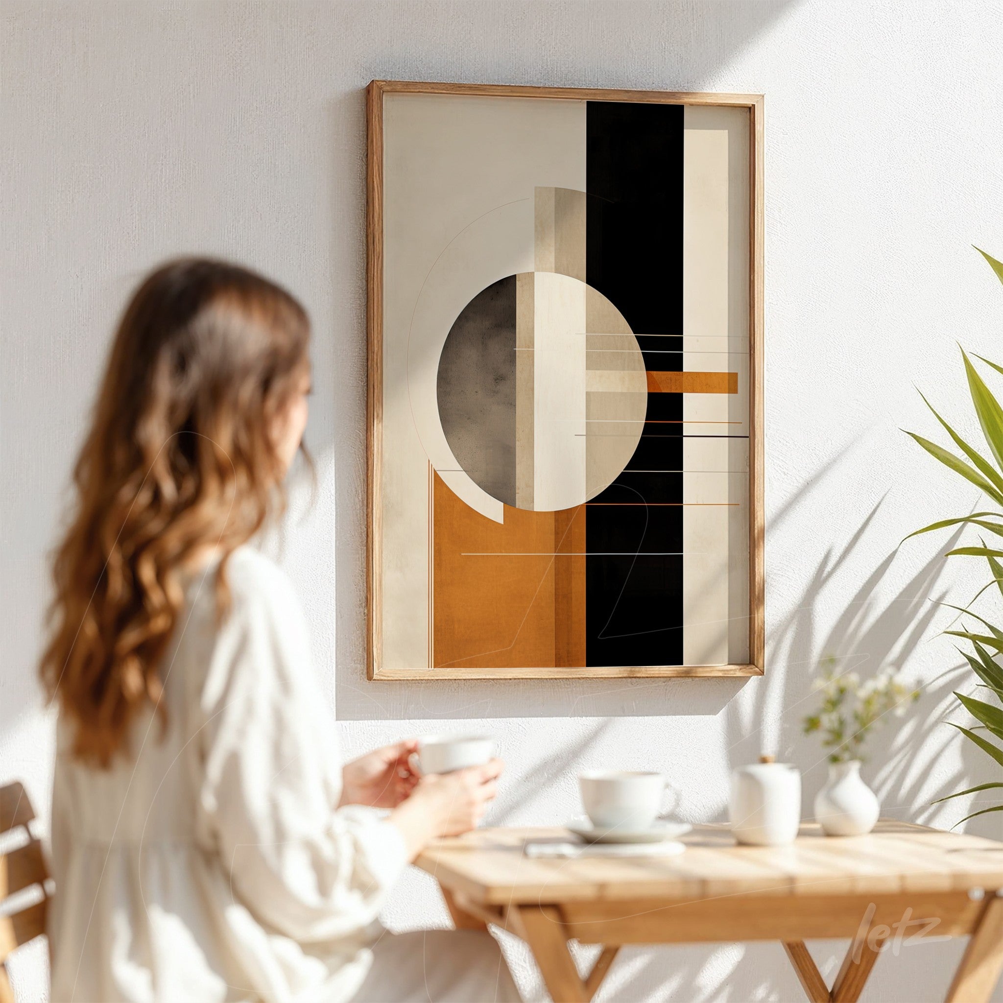 framed geometric art in earthy tones displayed on a white wall