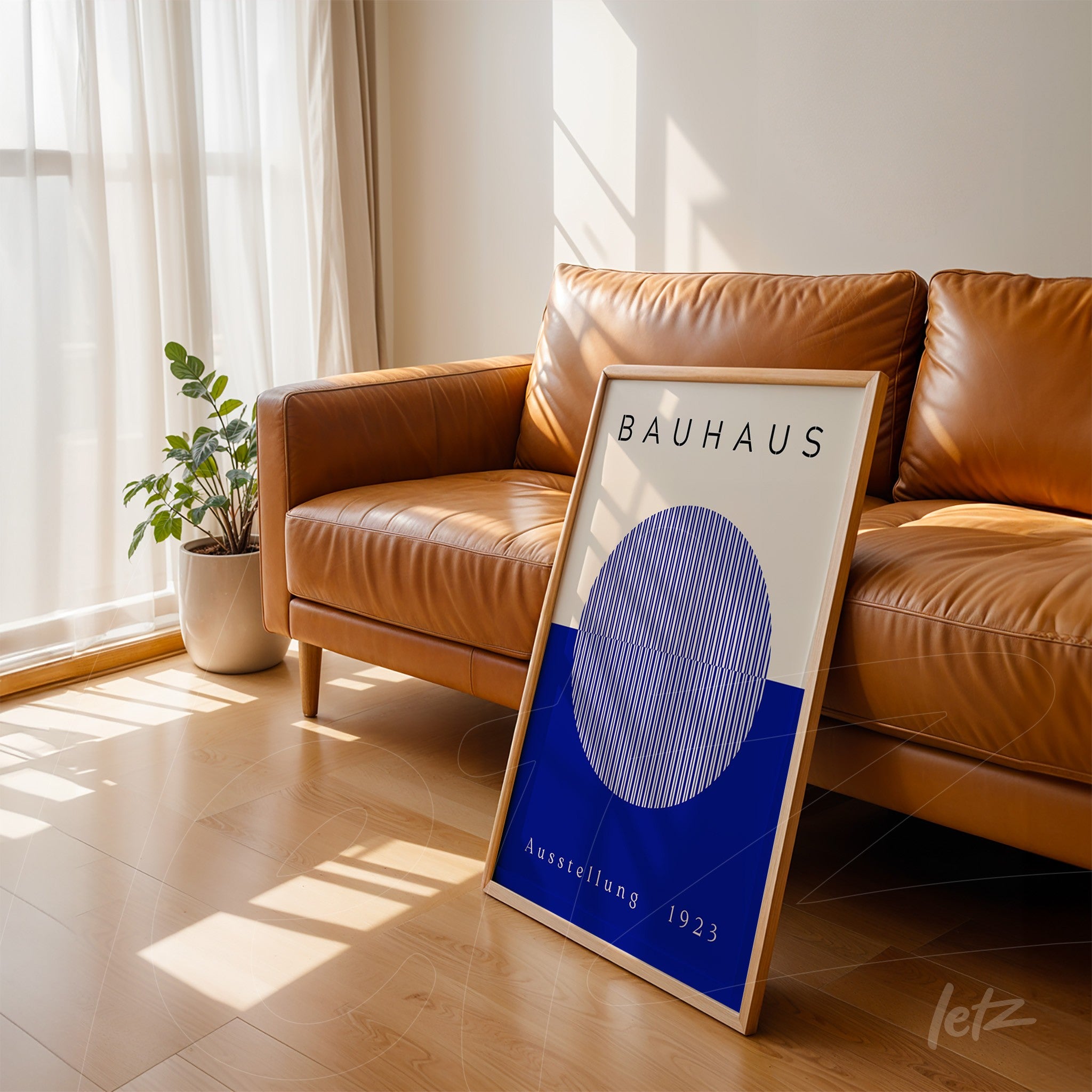 bauhaus style decorative art with light wood frame displayed leaning on a brown leather sofa in a well-lit room