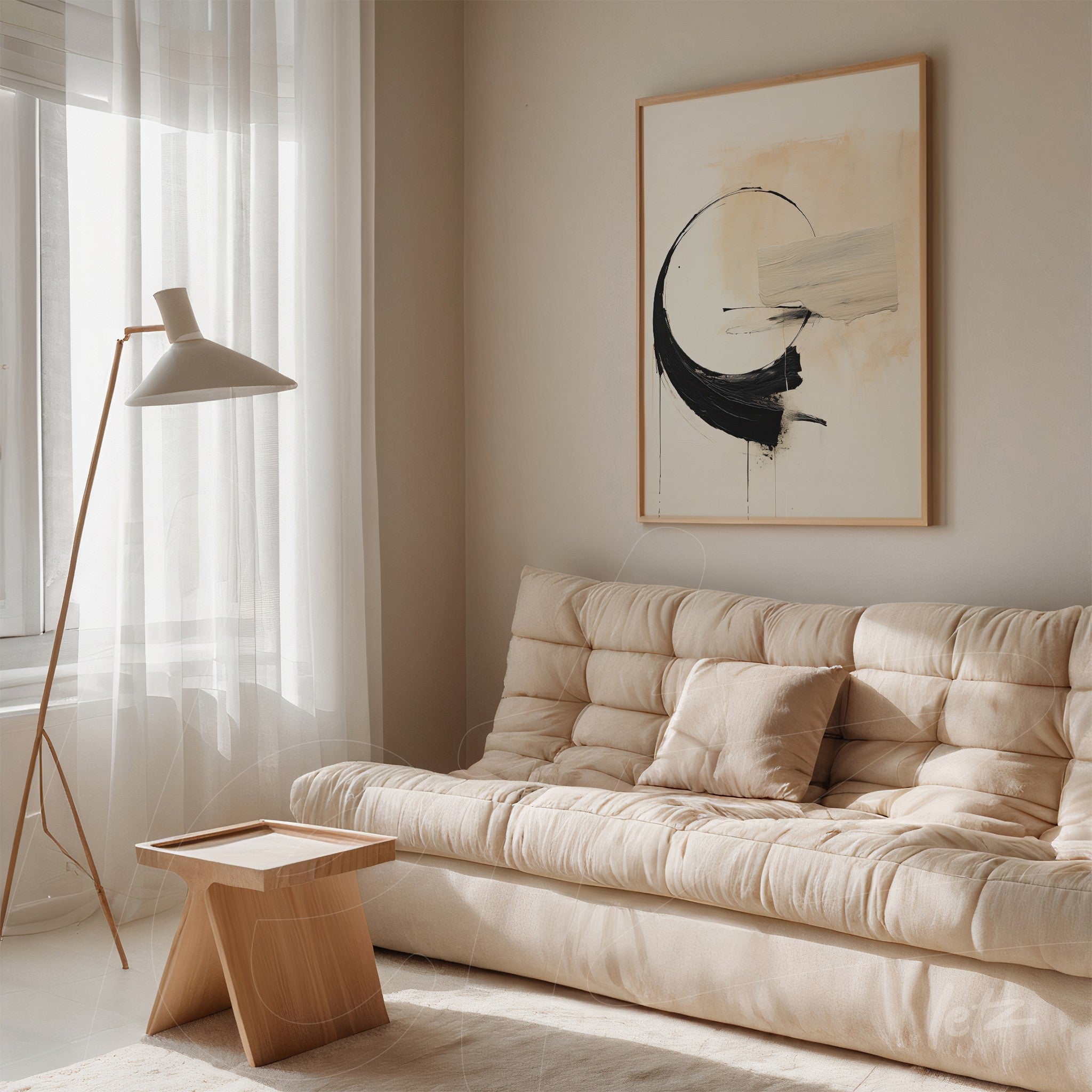 framed abstract artwork in light tones with black strokes displayed in a beige sofa setting featuring a modern lamp