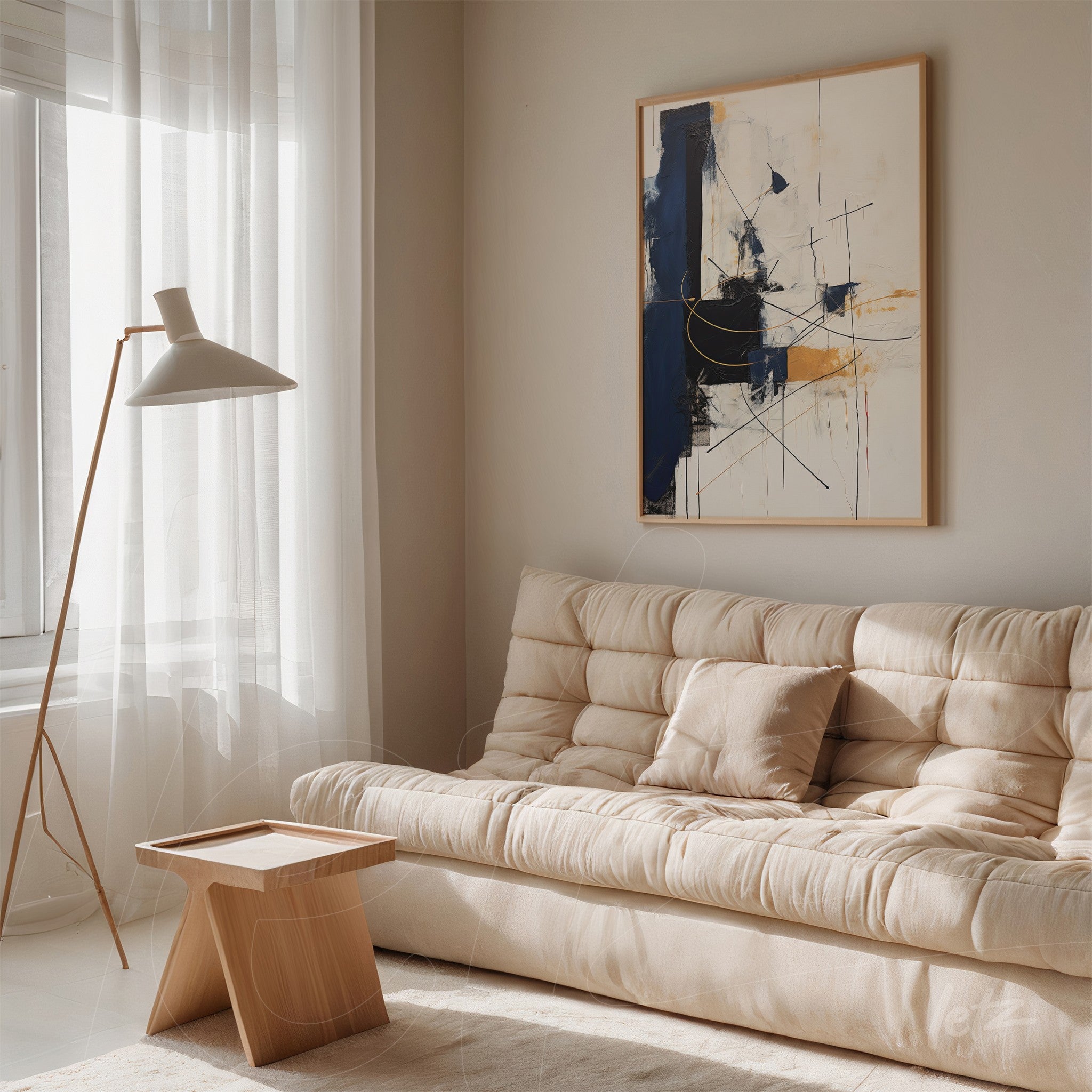 abstract artwork featuring dominant blue tones in a light frame above a beige sofa in a bright living room