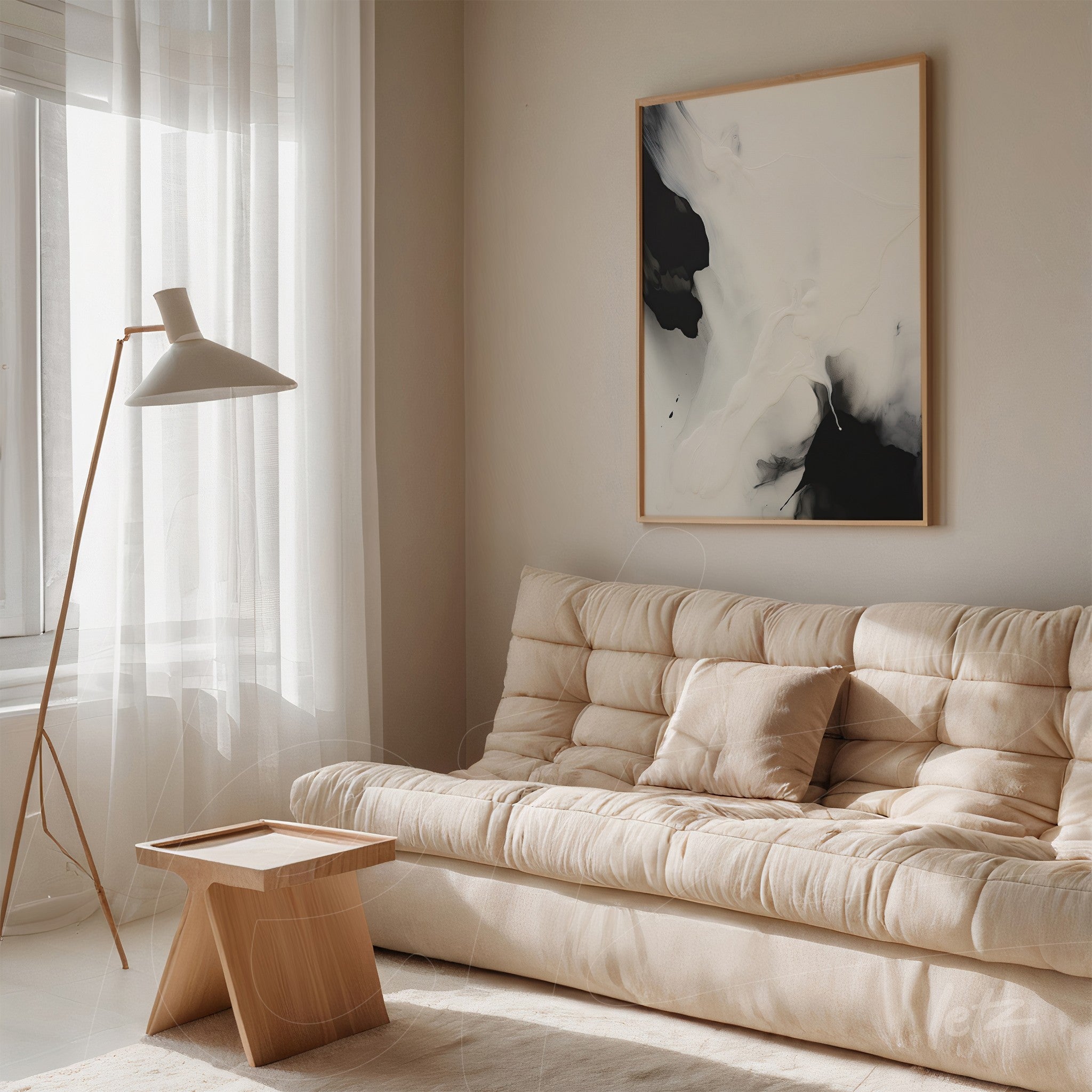 framed abstract art in black and white with light frame displayed above a beige sofa in a bright living room