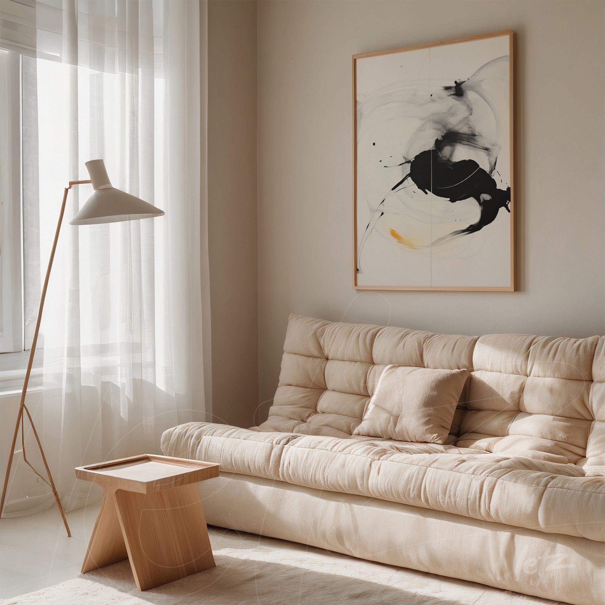 abstract wall art in light frame featuring black smudges and fluid curves displayed on living room wall with light sofa
