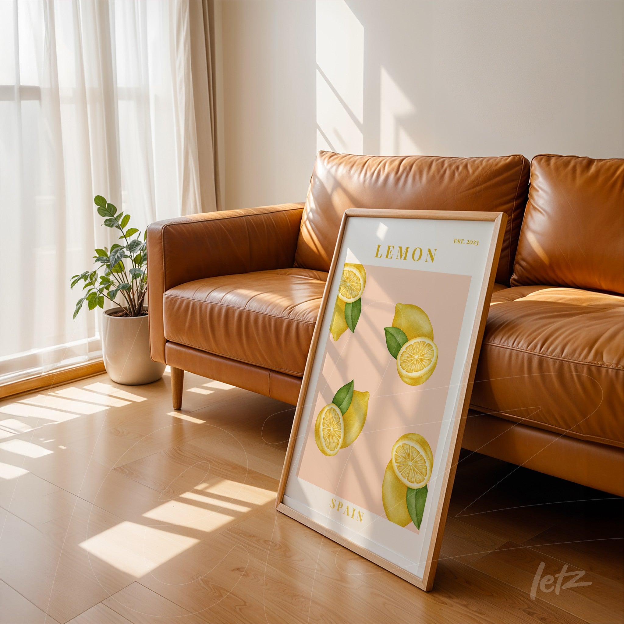 framed art of sliced lemons with white frame leaning against brown leather sofa