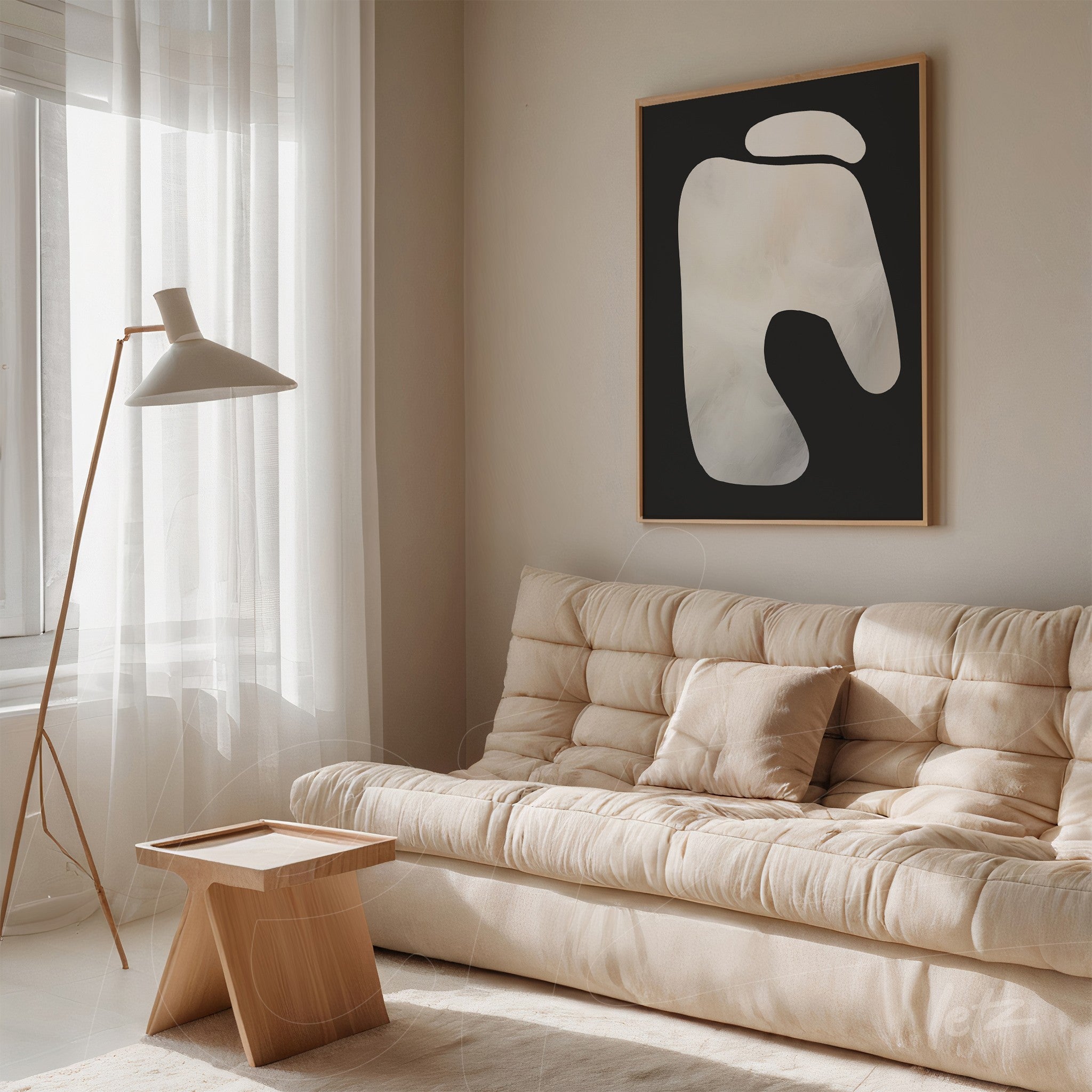 abstract wall art with fluid shapes in light tones in a light wood frame displayed in a room with a light sofa and soft lighting