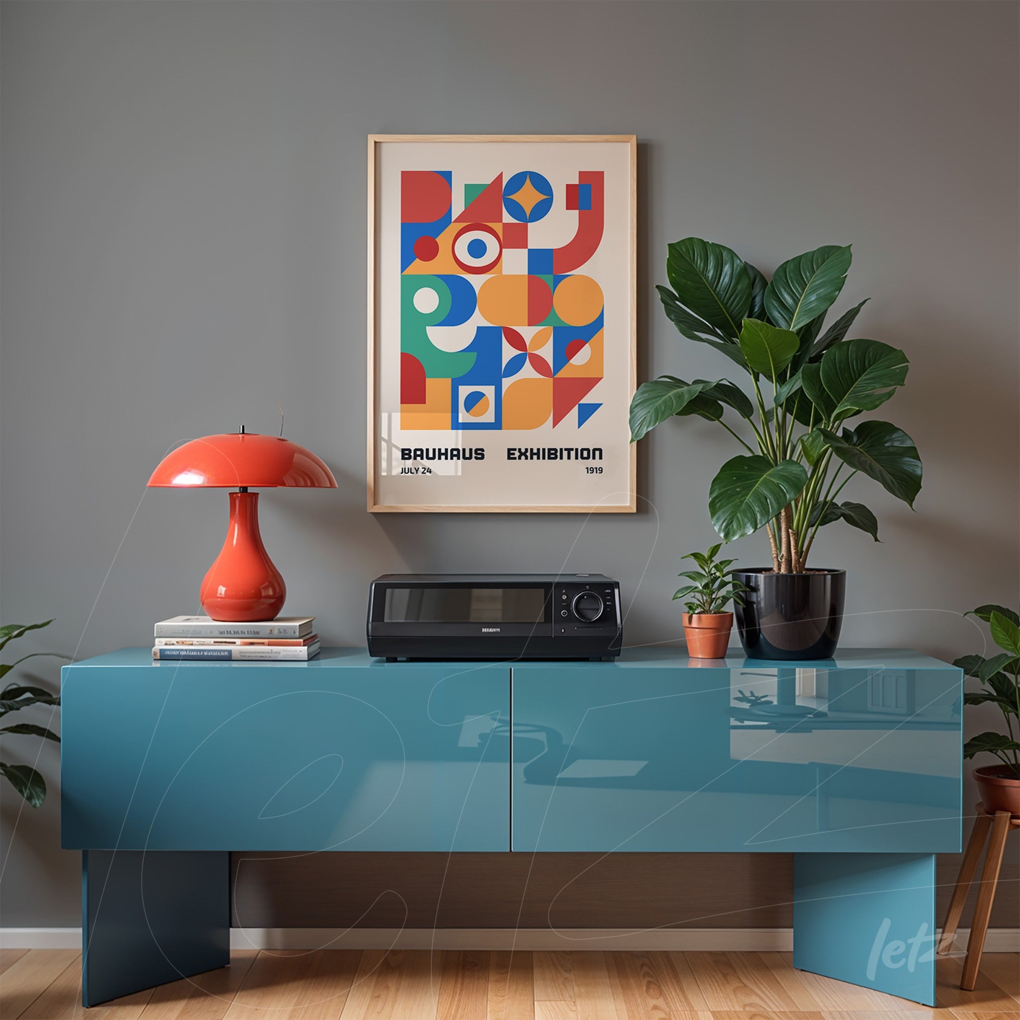 poster print with geometric design of Bauhaus exhibition in light wood frame displayed above blue cabinet against gray wall