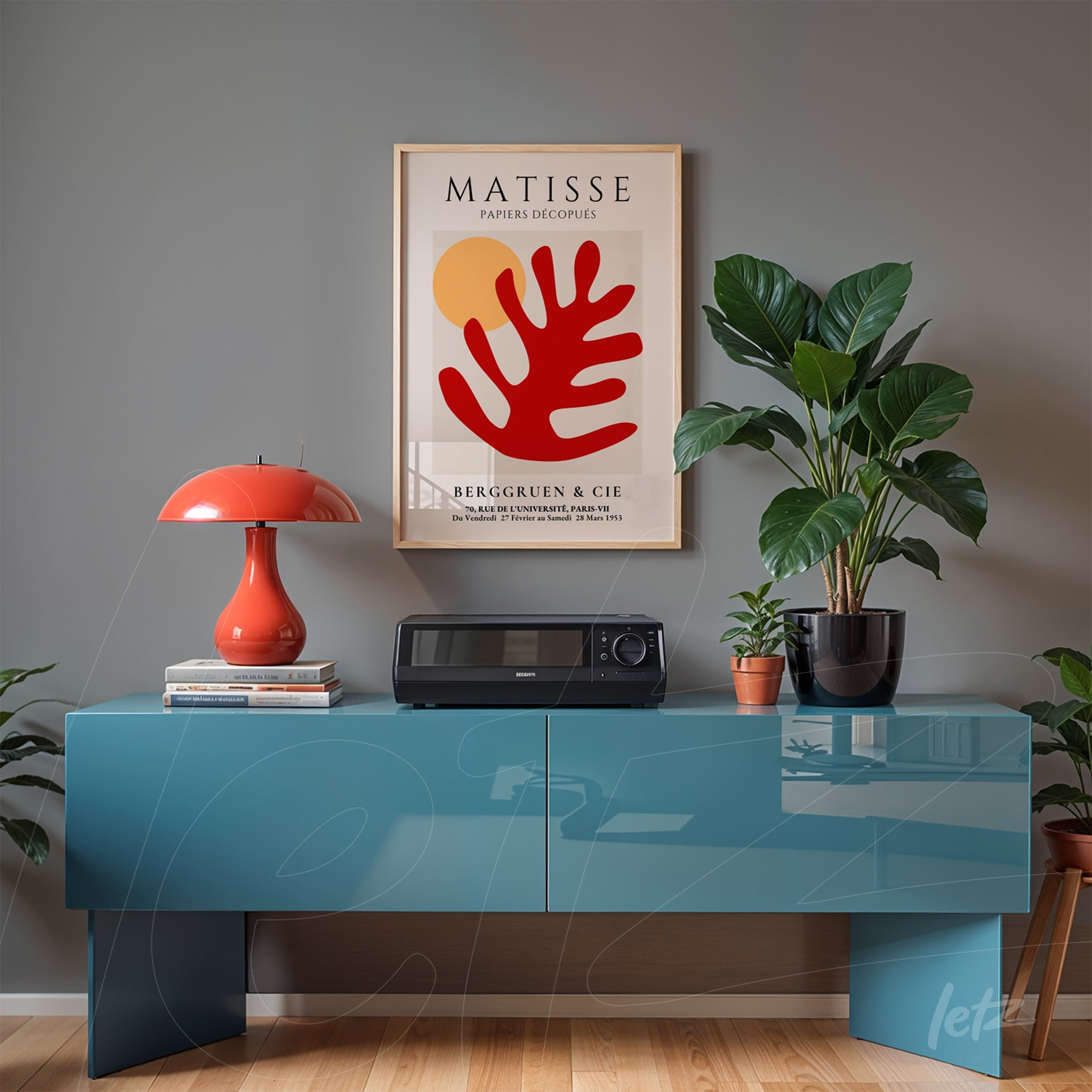 framed modern artwork by Matisse featuring red and yellow colors displayed above a blue sideboard in a contemporary setting