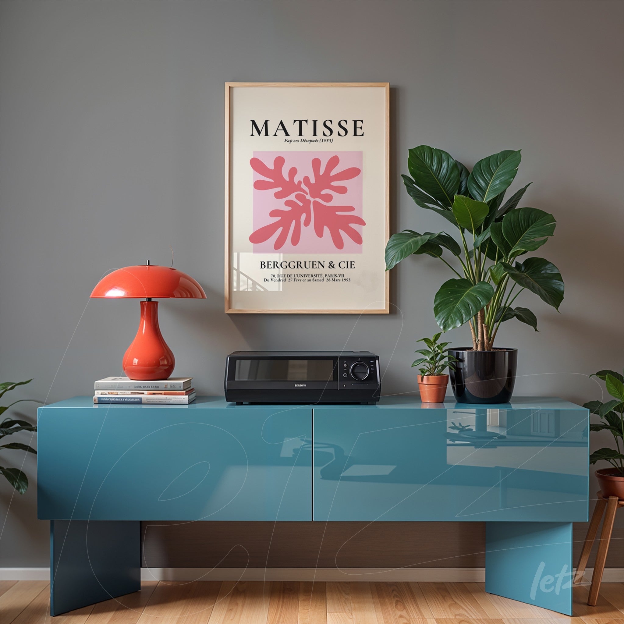 framed modern art print of coral plants in light frame above blue sideboard in minimalist setting