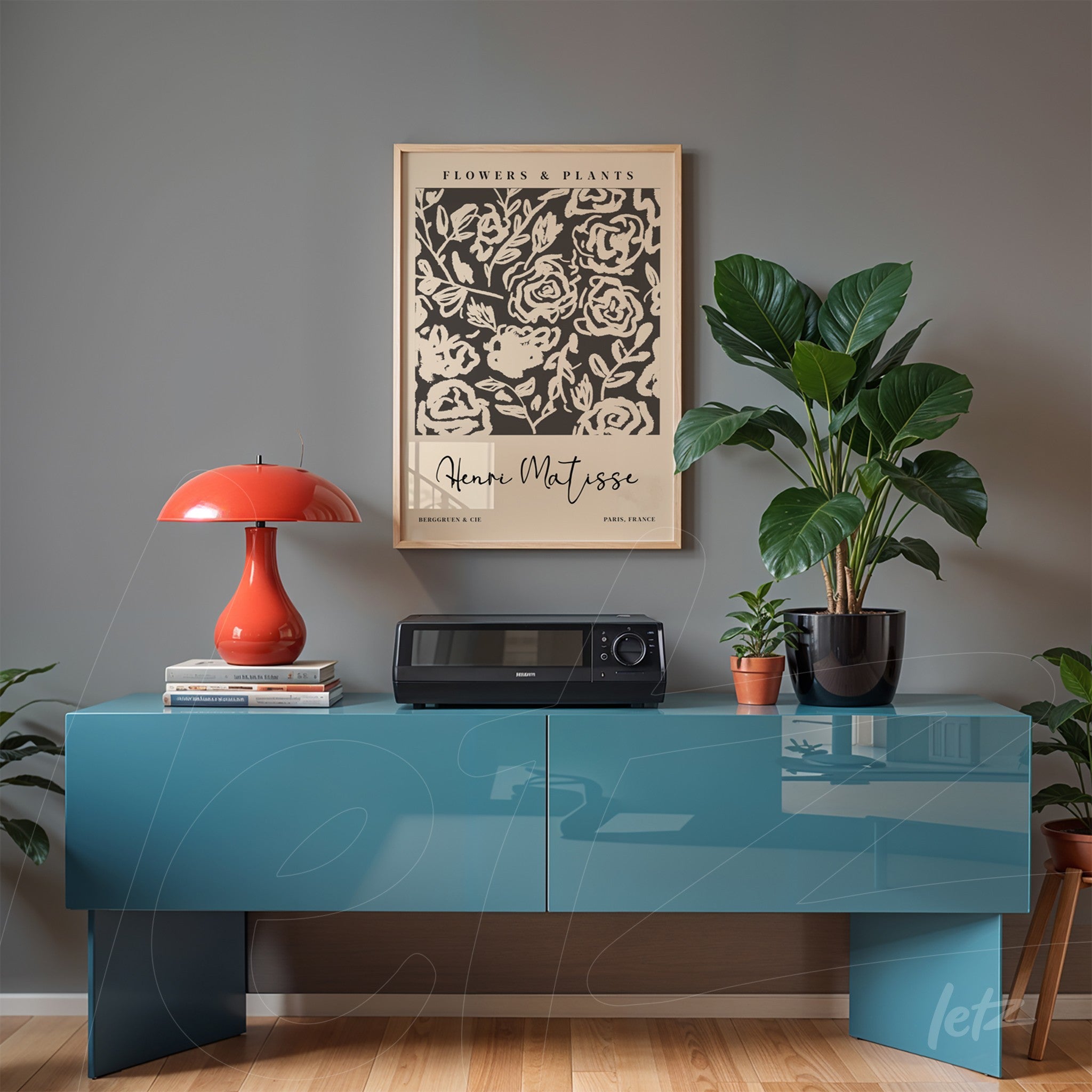 framed art print of matisse displayed above a modern blue furniture piece, accompanied by an orange lamp and potted plants