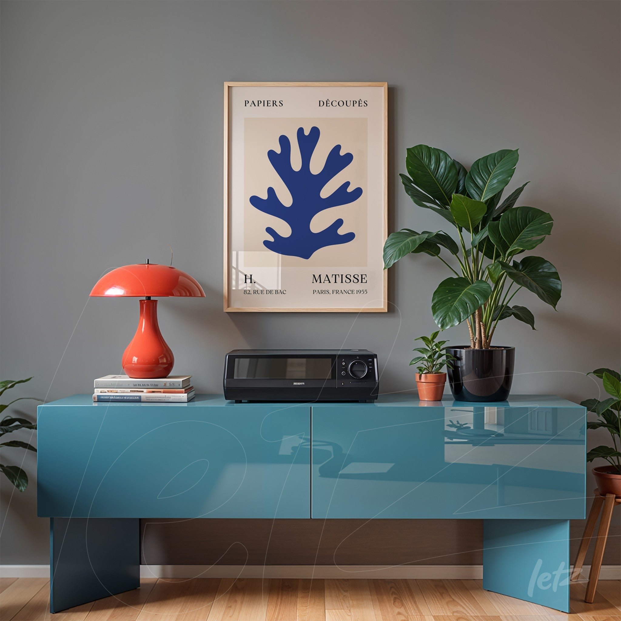 framed art print of navy blue coral displayed above a modern cabinet in a minimalist setting
