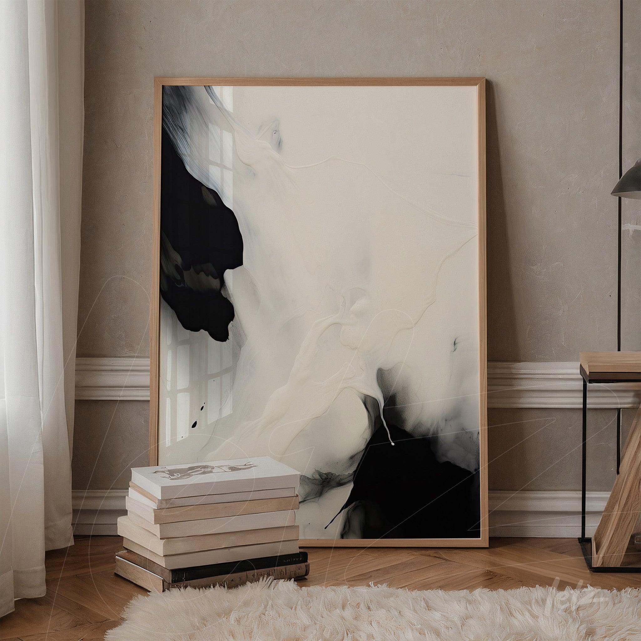 framed artwork featuring abstract design in black and white displayed in a neutral room with wooden furniture