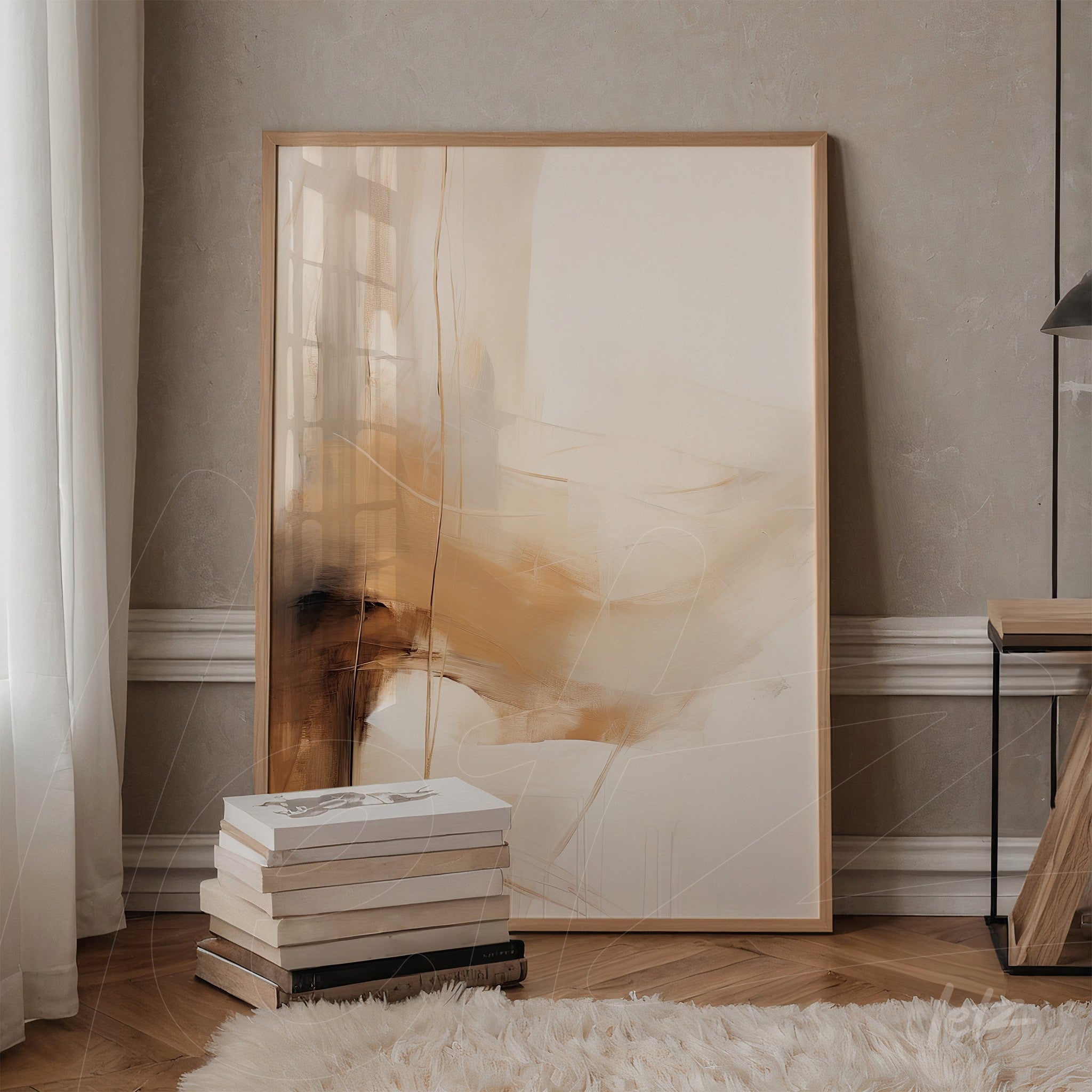 abstract artwork in beige and caramel tones in light frame leaning next to a wooden table
