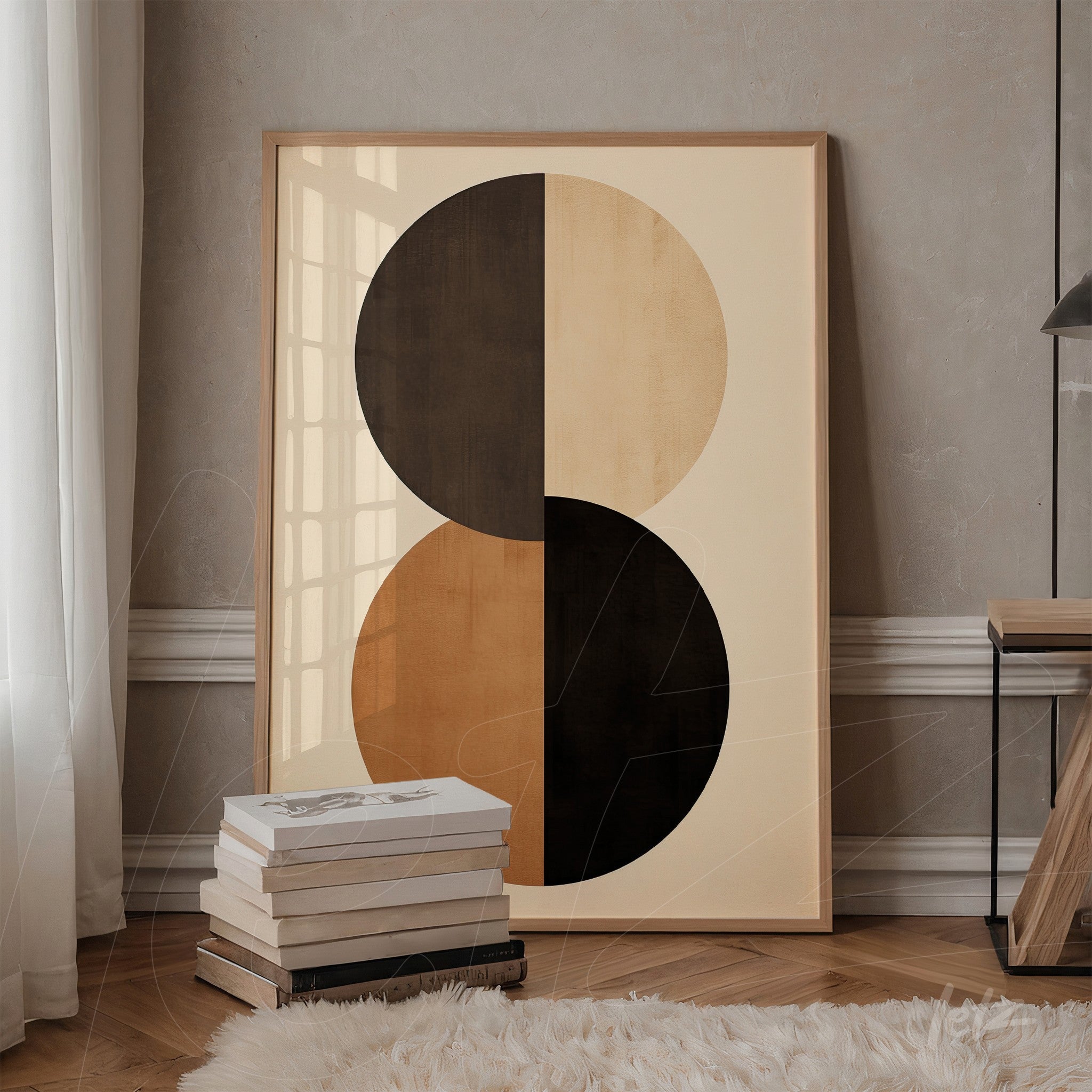 abstract wall art in brown and black tones with light wood frame displayed in an indoor setting beside a stack of books