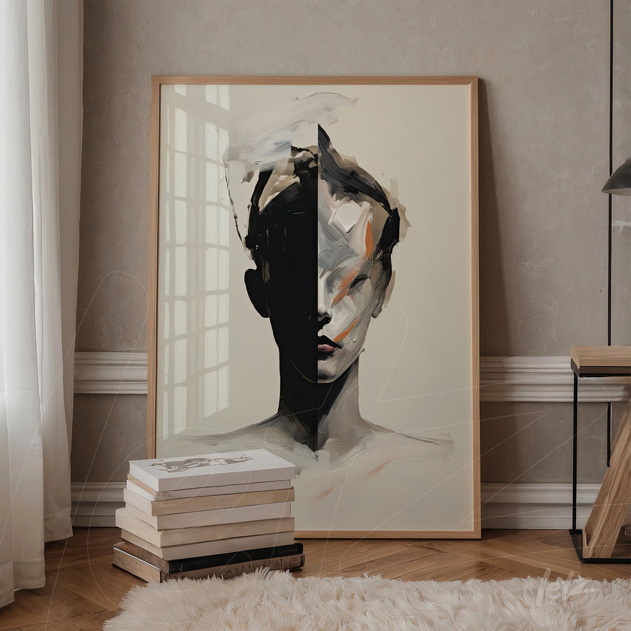 framed abstract art depicting a split face in black and beige tones, displayed against a soft wall